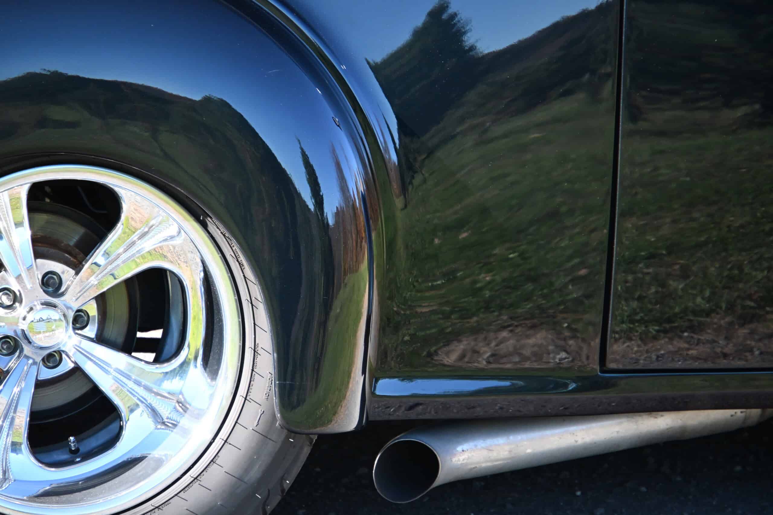 1941 Willys Custom Street Rod — Close-up of classic car wheel and side panel with exhaust pipe.