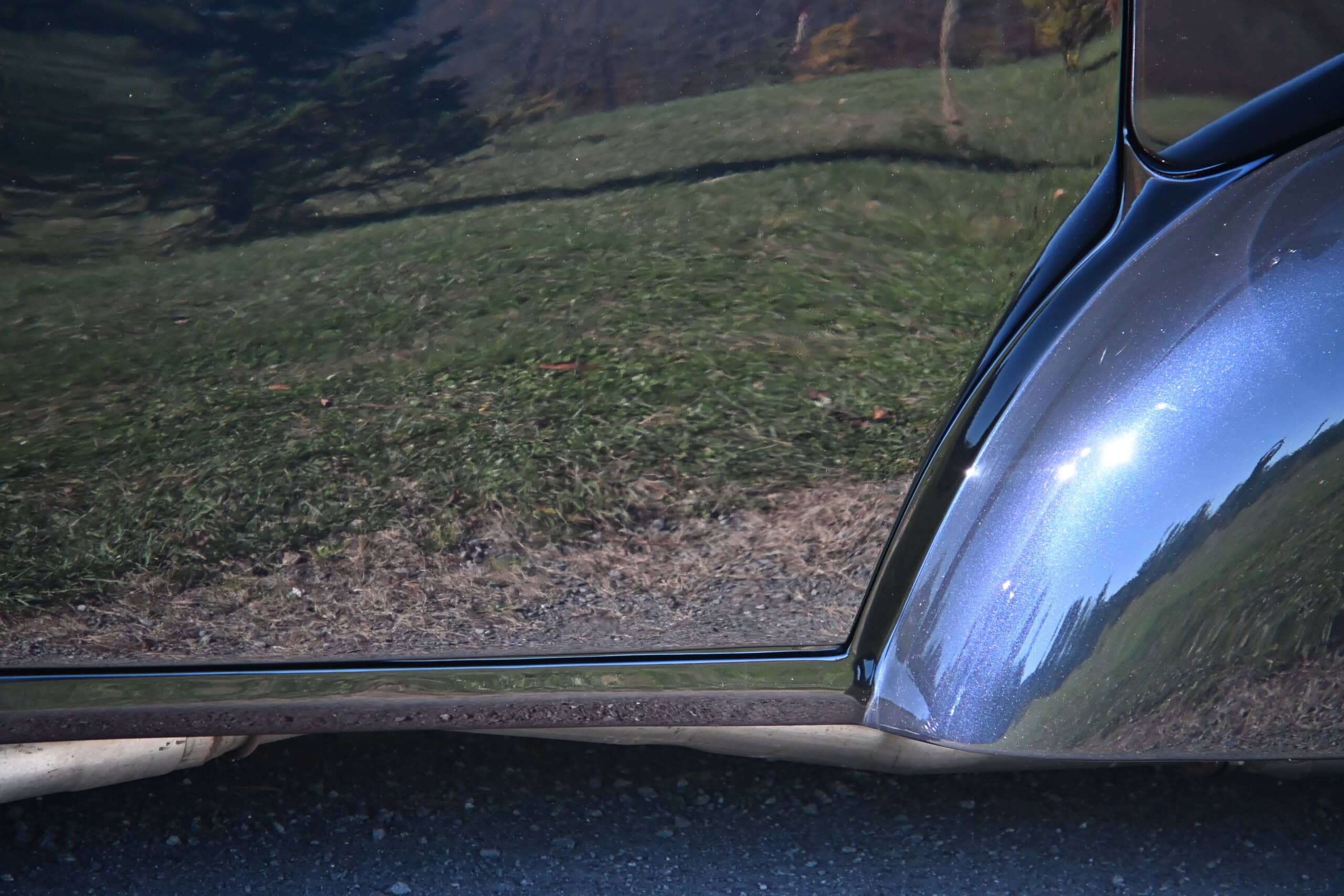1941 Willys Custom Street Rod — Close-up of the car's shiny metallic exterior and window.