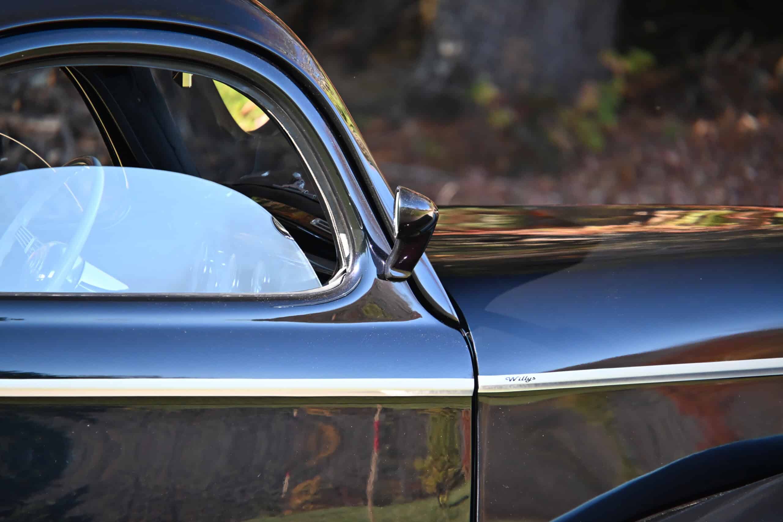 1941 Willys Custom Street Rod — Close-up of classic car door and side mirror with black paint.