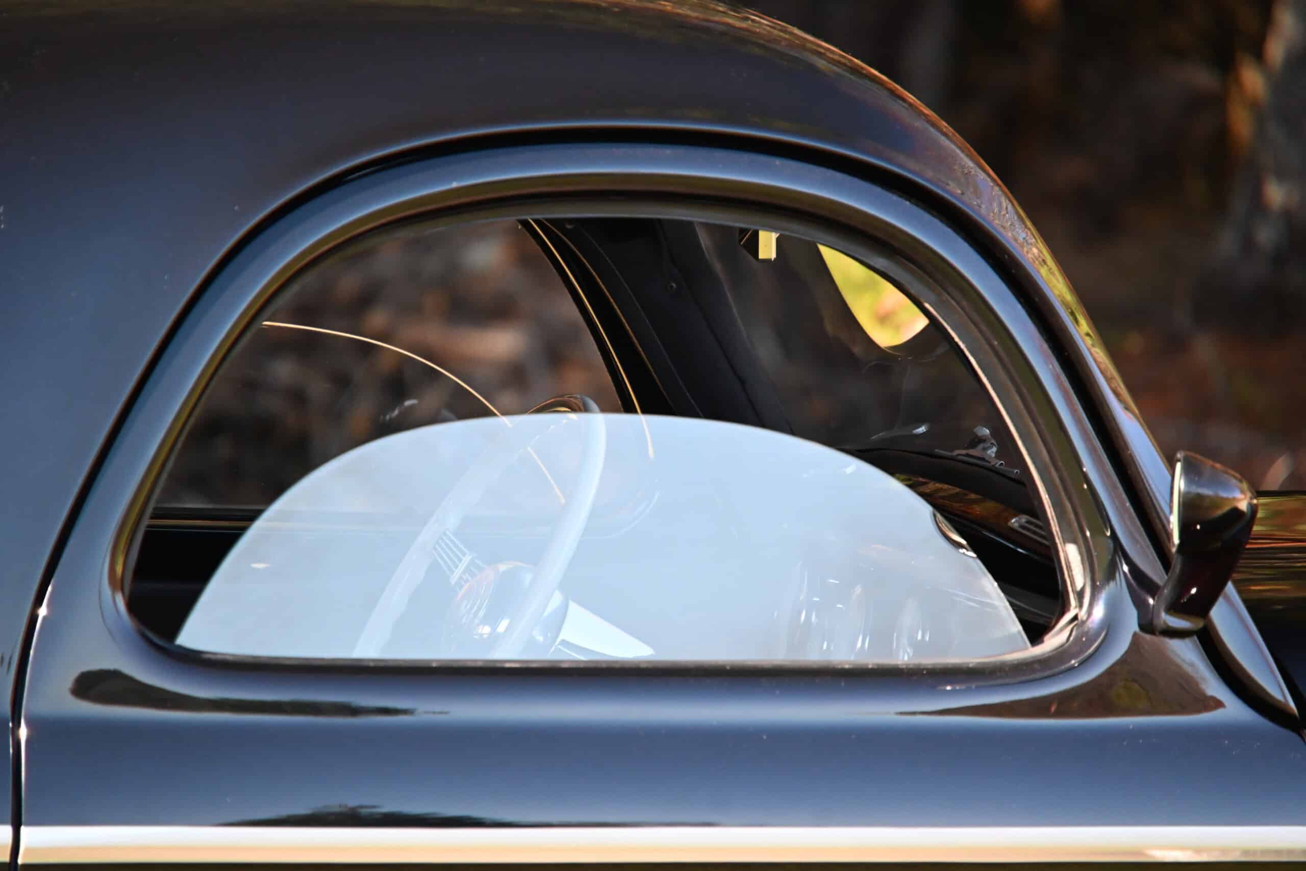 1941 Willys Custom Street Rod — Close-up of classic car with rounded window and black paint.