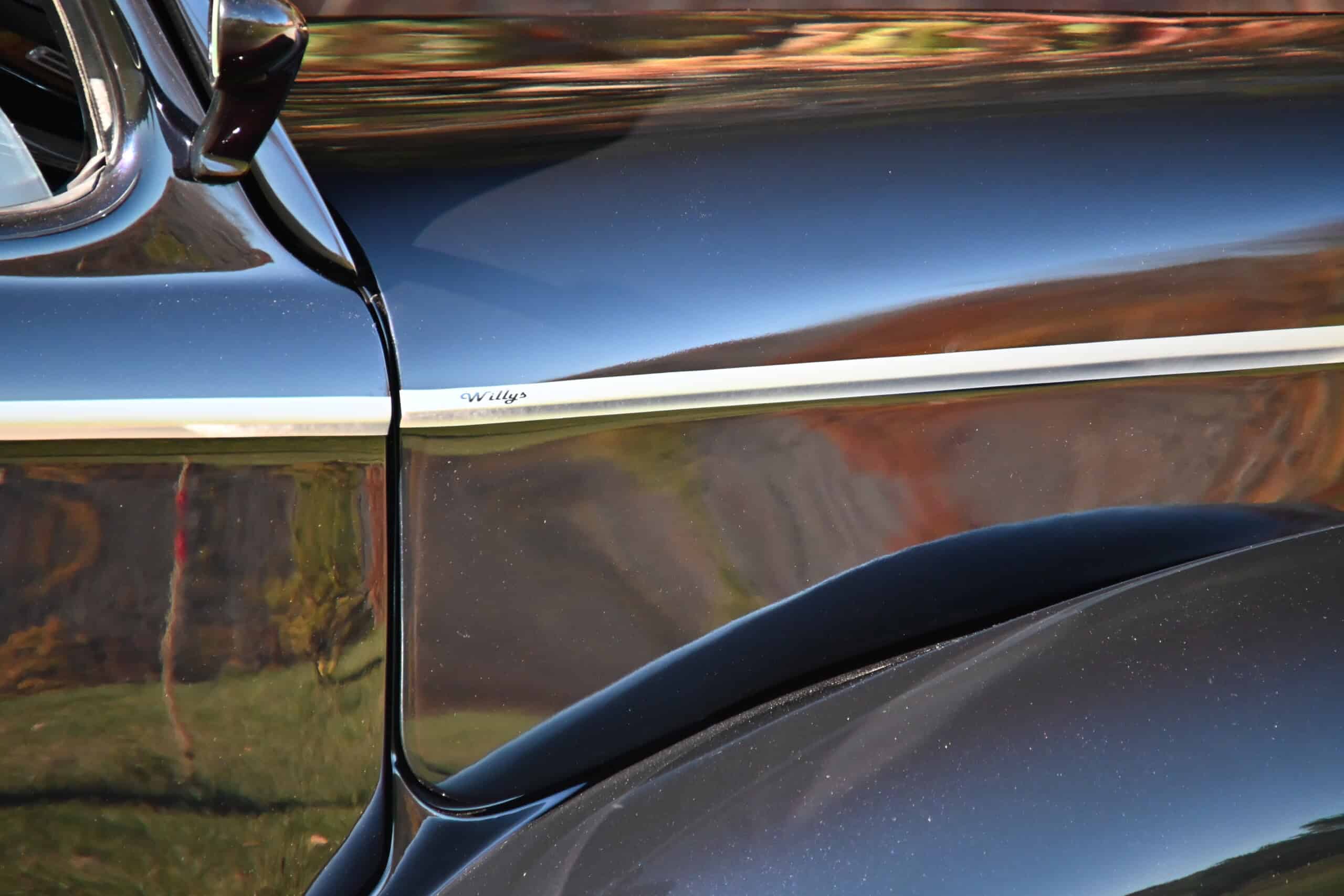 1941 Willys Custom Street Rod — Close-up of classic car body with chrome trim and black paint.