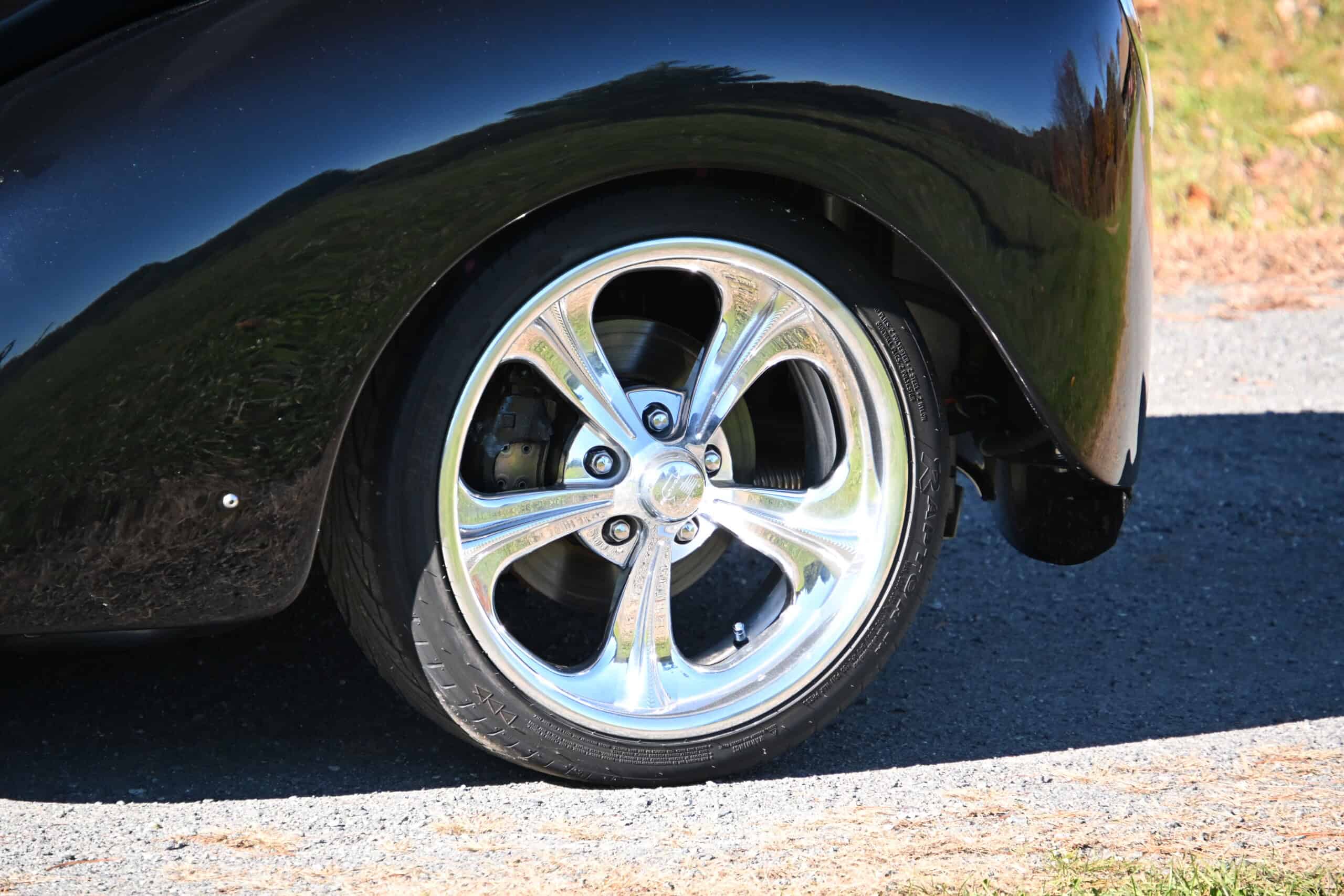 1941 Willys Custom Street Rod — Close-up of a classic car's shiny alloy wheel and tire.