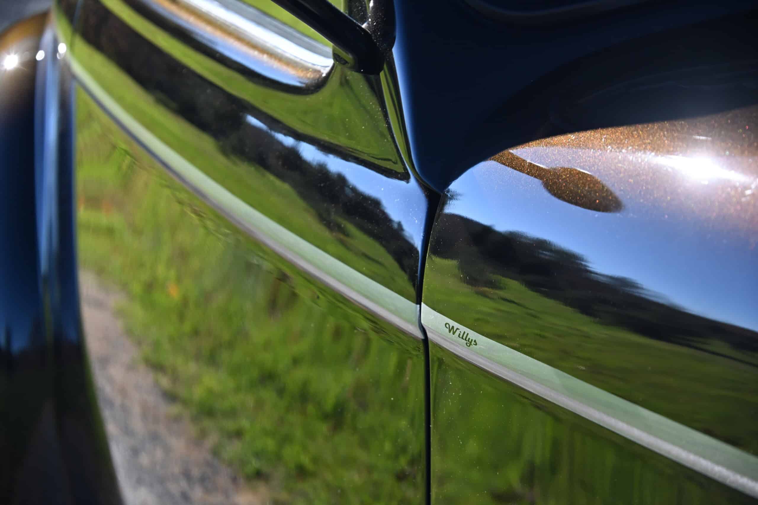 1941 Willys Custom Street Rod — Close-up of classic car body with reflection and chrome trim.