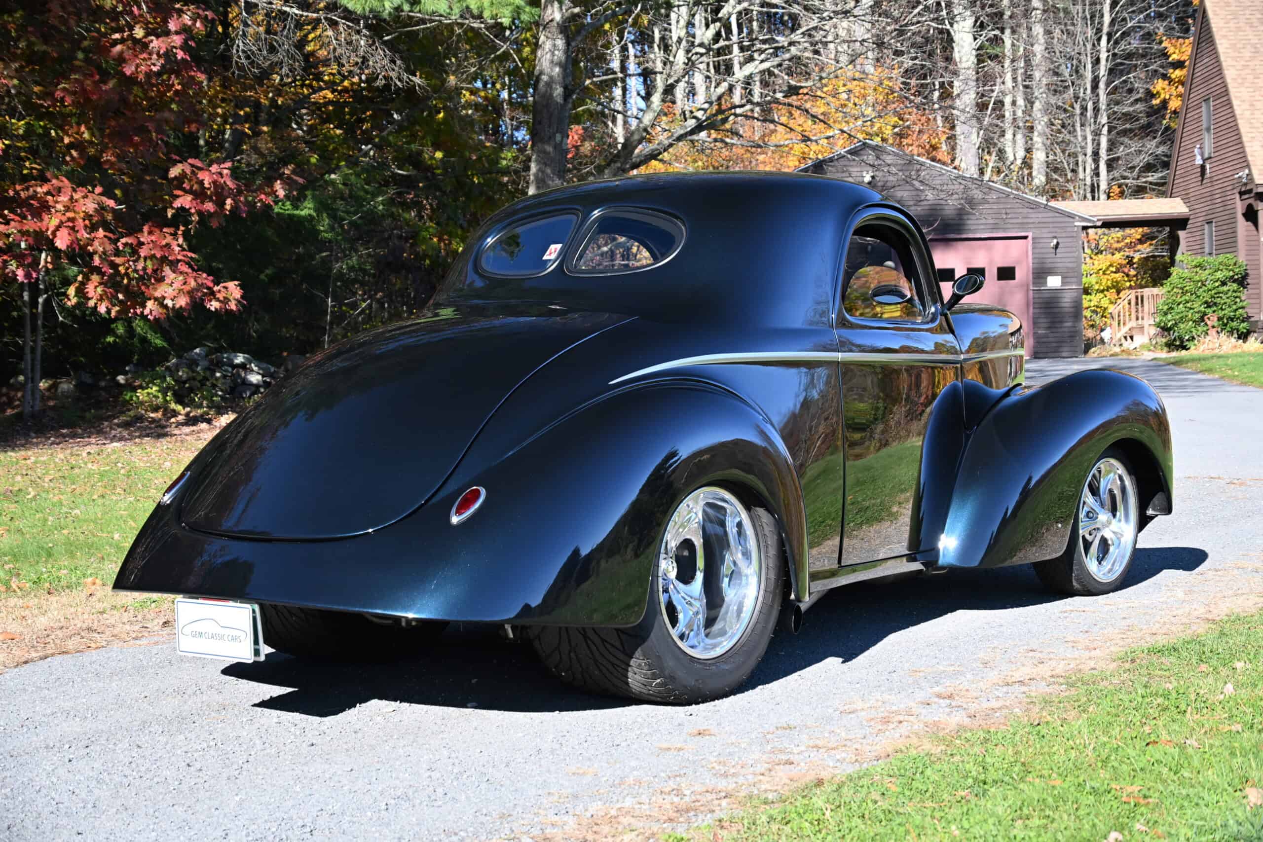 1941 Willys Custom Street Rod — Black classic car with rounded body and chrome wheels.