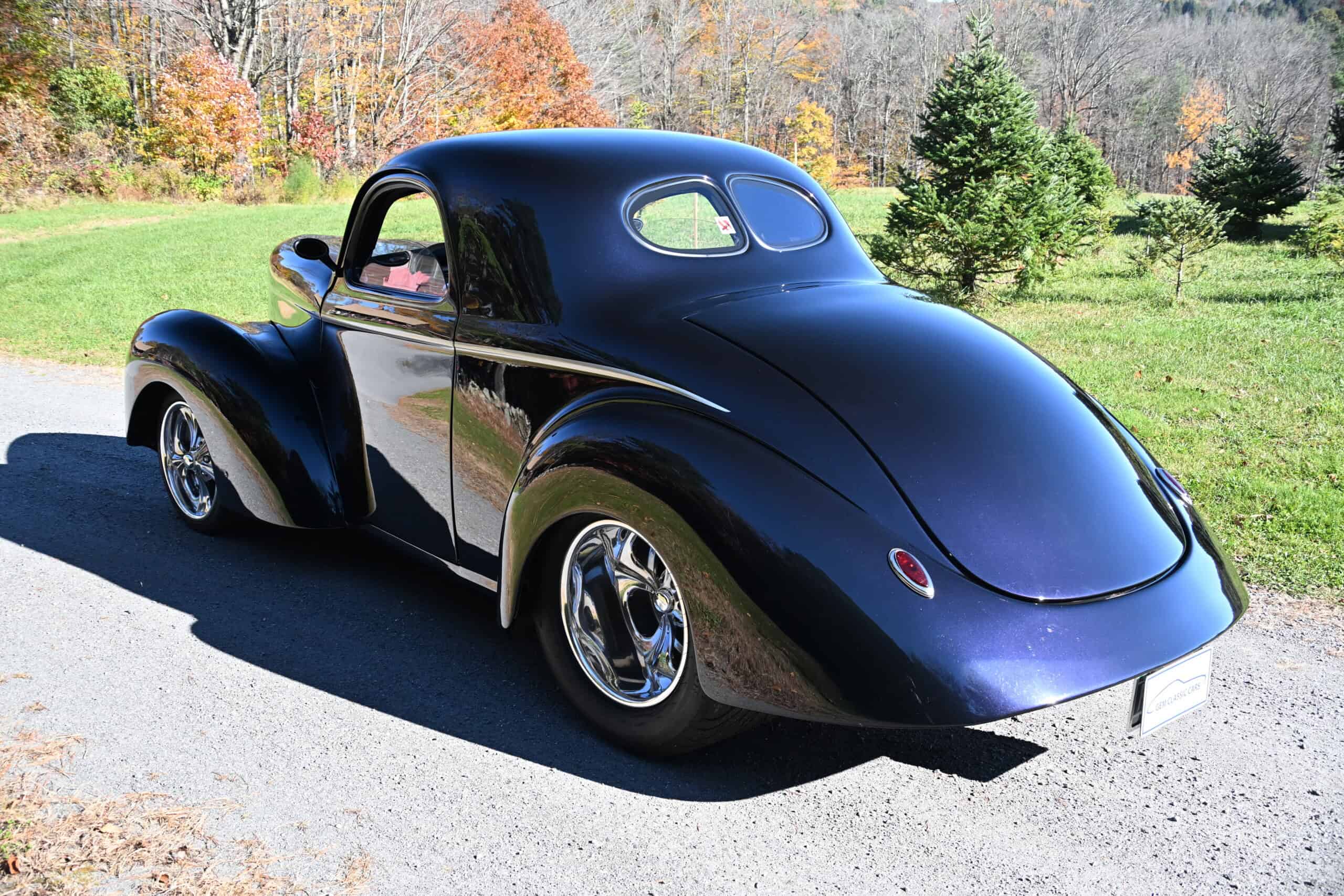1941 Willys Custom Street Rod — Black classic car with rounded body and chrome wheels.