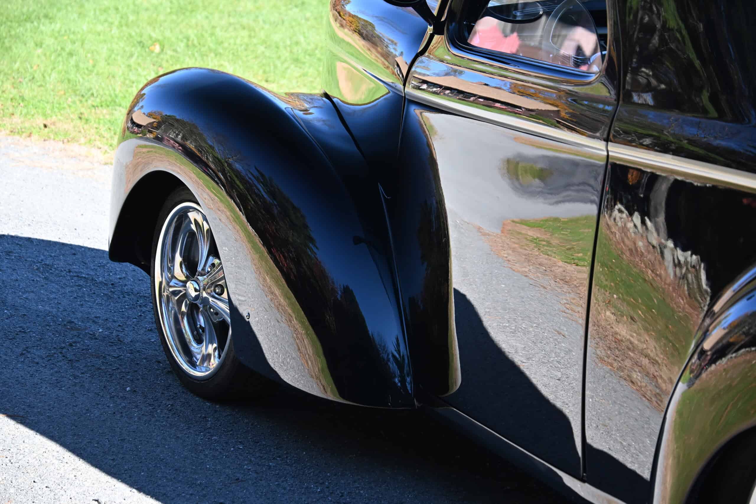 1941 Willys Custom Street Rod — Close-up of a black classic car's front fender and chrome wheel.