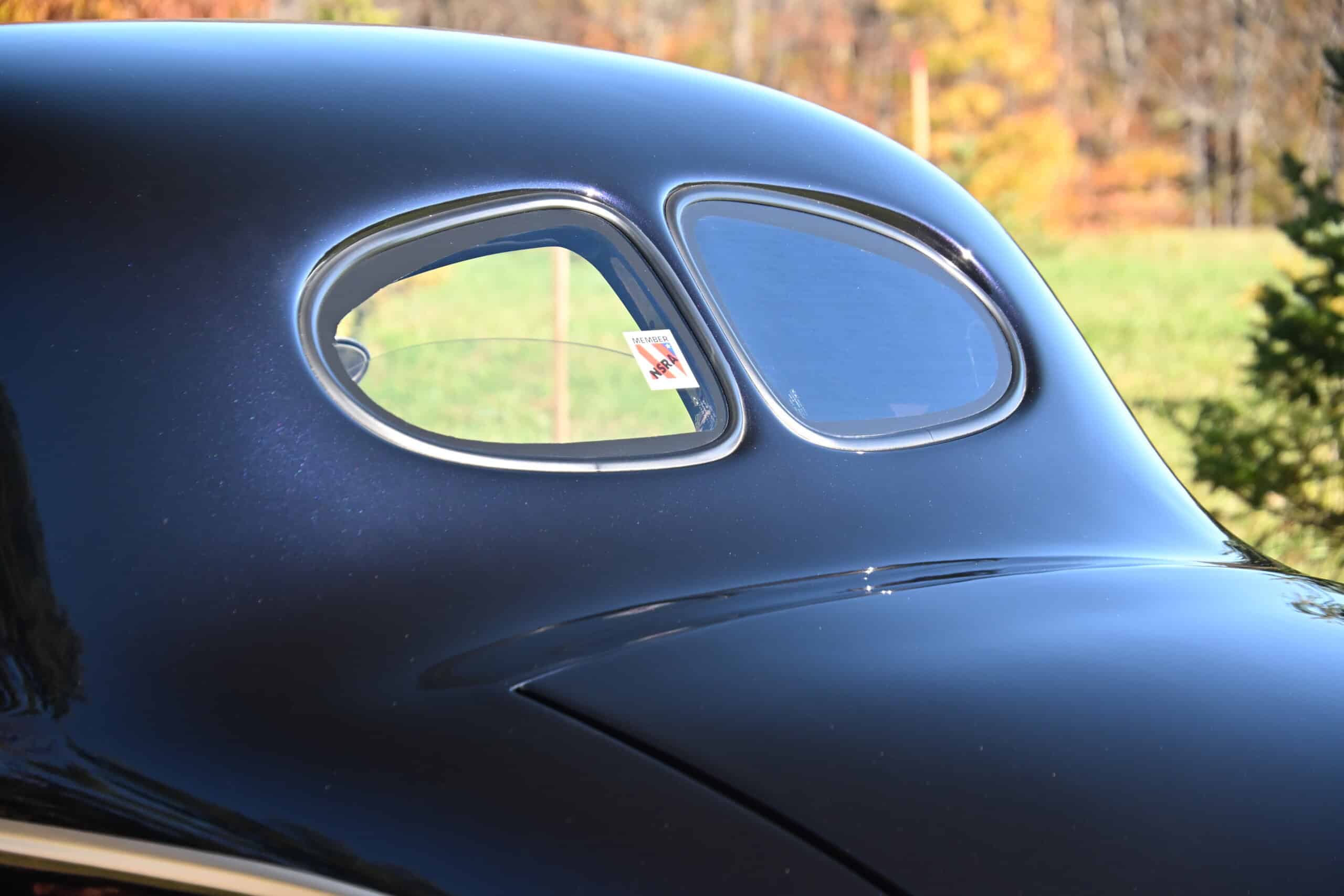 1941 Willys Custom Street Rod — Close-up of classic car with rounded windows and glossy black paint.