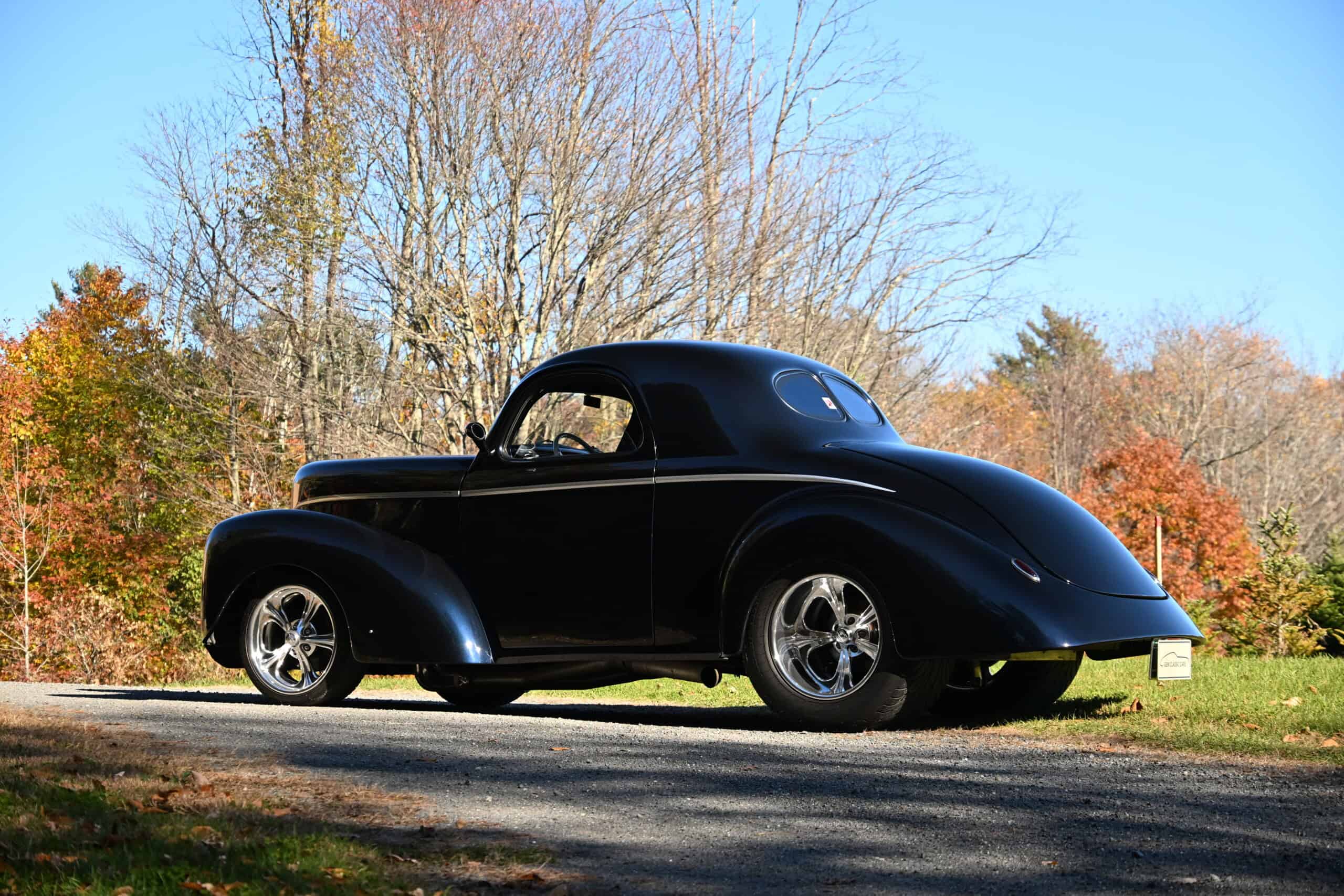 1941 Willys Custom Street Rod — Black classic car with rounded body and chrome wheels outdoors.