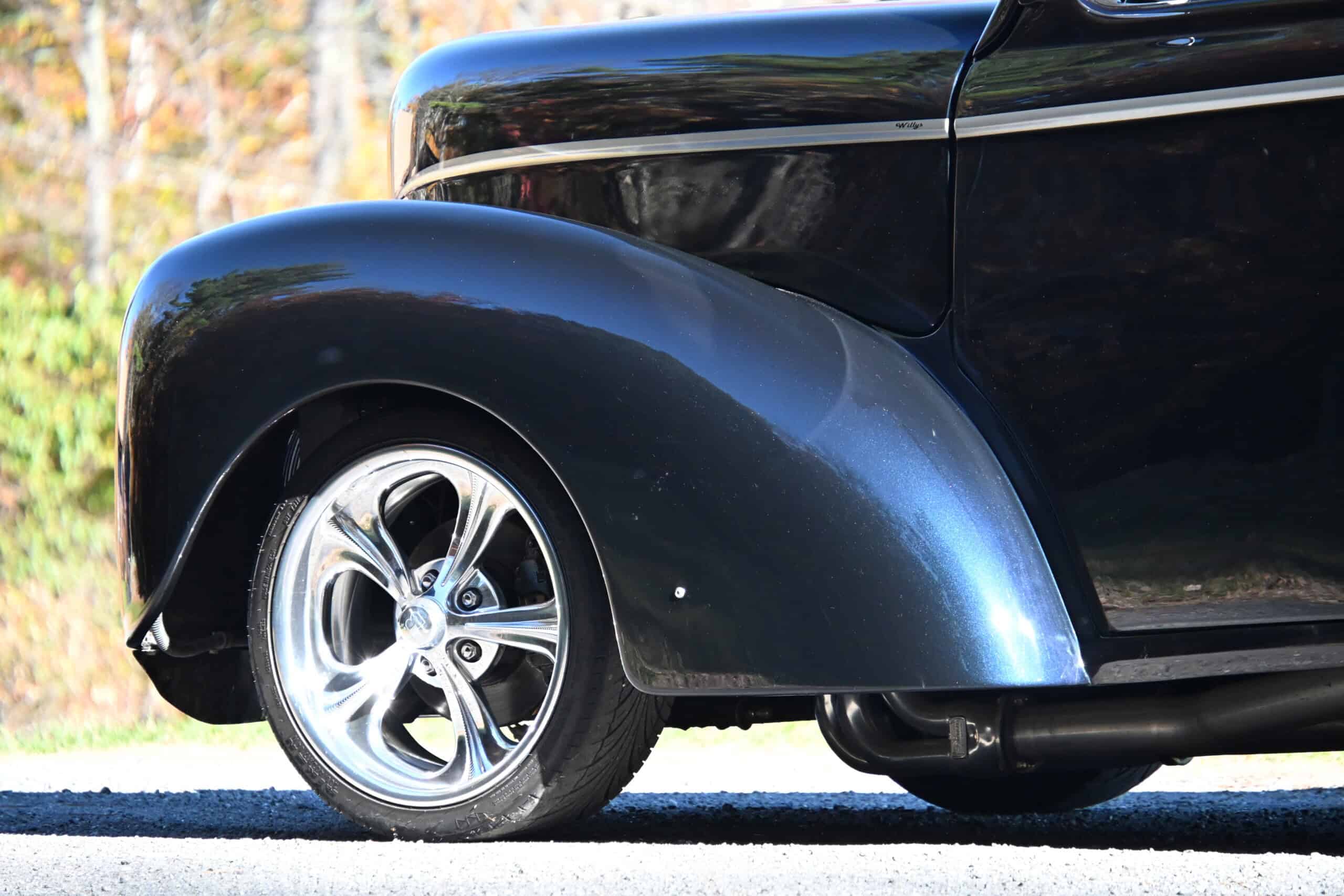 1941 Willys Custom Street Rod — Close-up of classic car wheel and fender with black paint.