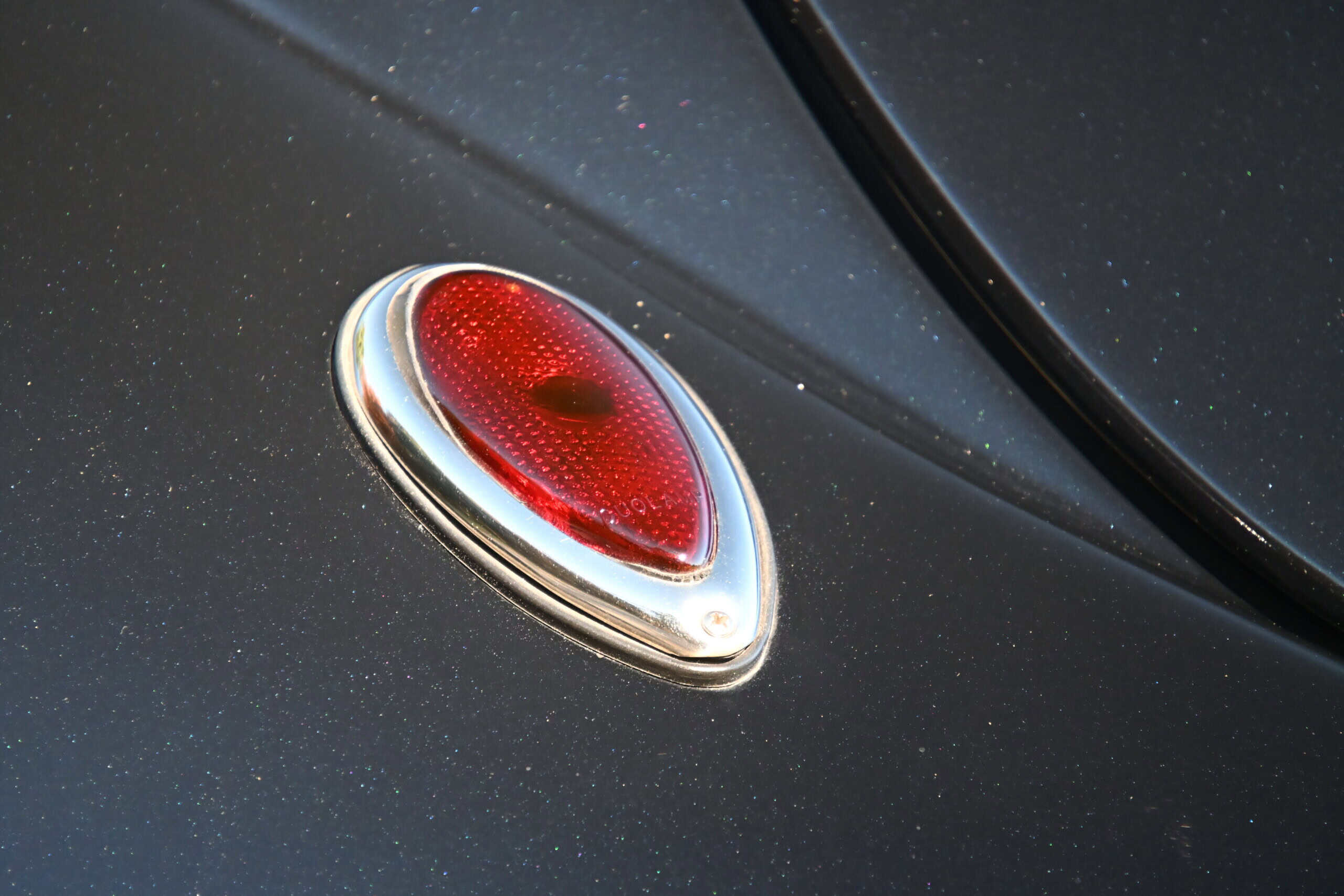 1941 Willys Custom Street Rod — Red tail light on a classic car with black paint.
