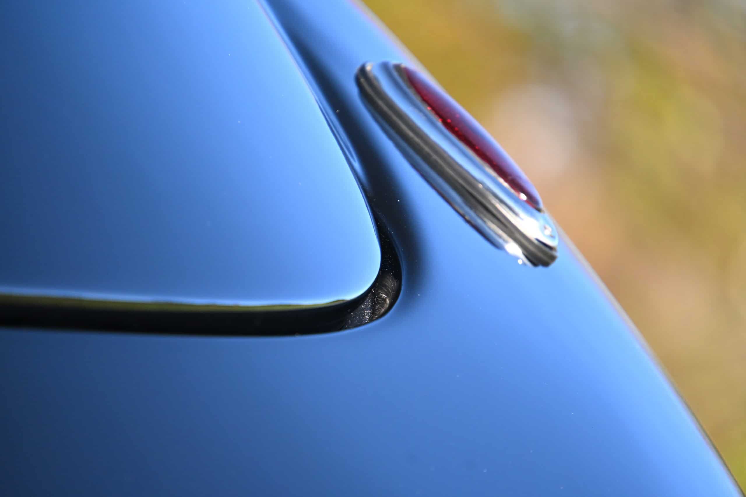 1941 Willys Custom Street Rod — Close-up of classic car tail light with blue body and chrome trim.