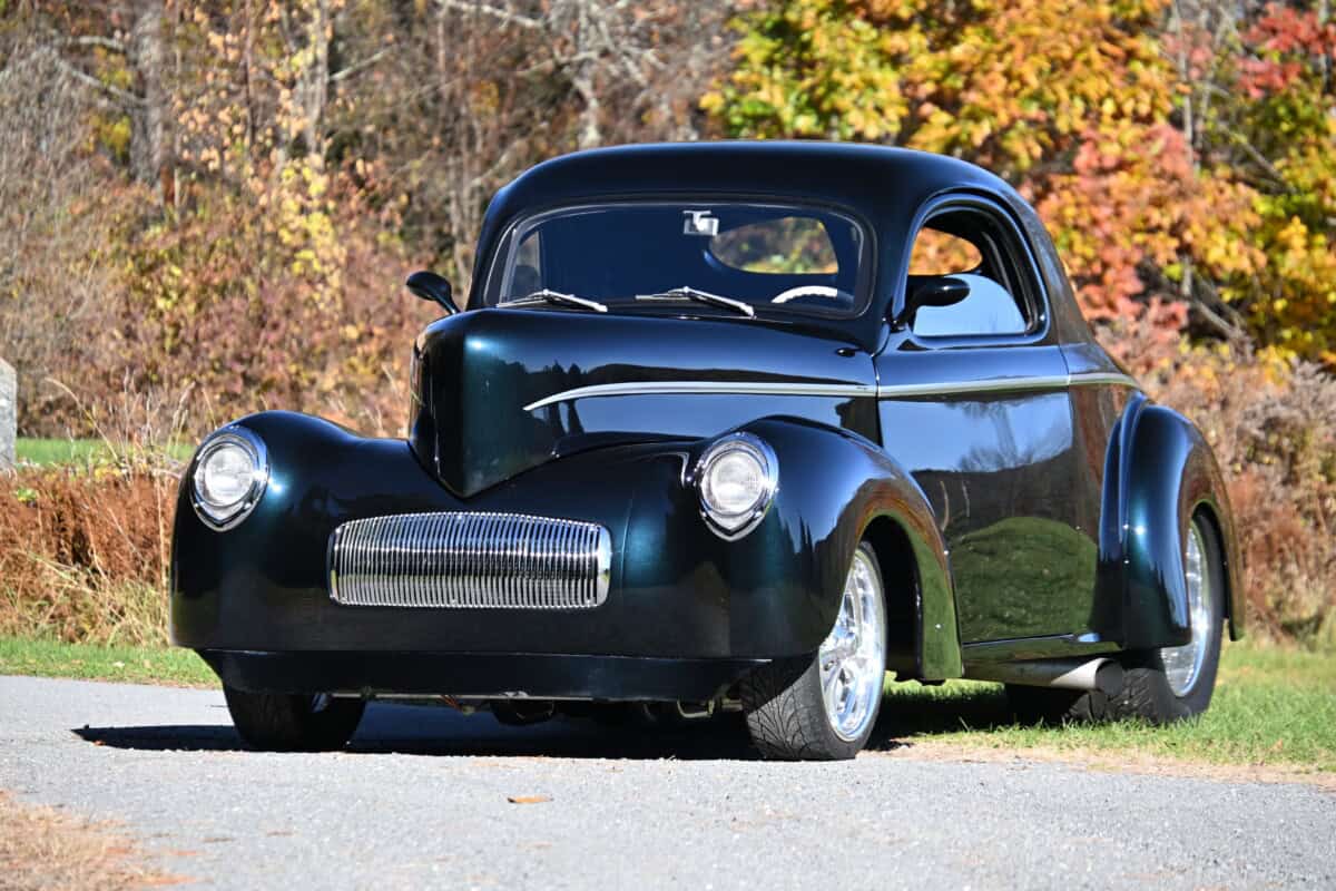 1941 Willys Custom Street Rod — Black classic car parked outdoors with autumn trees in background.