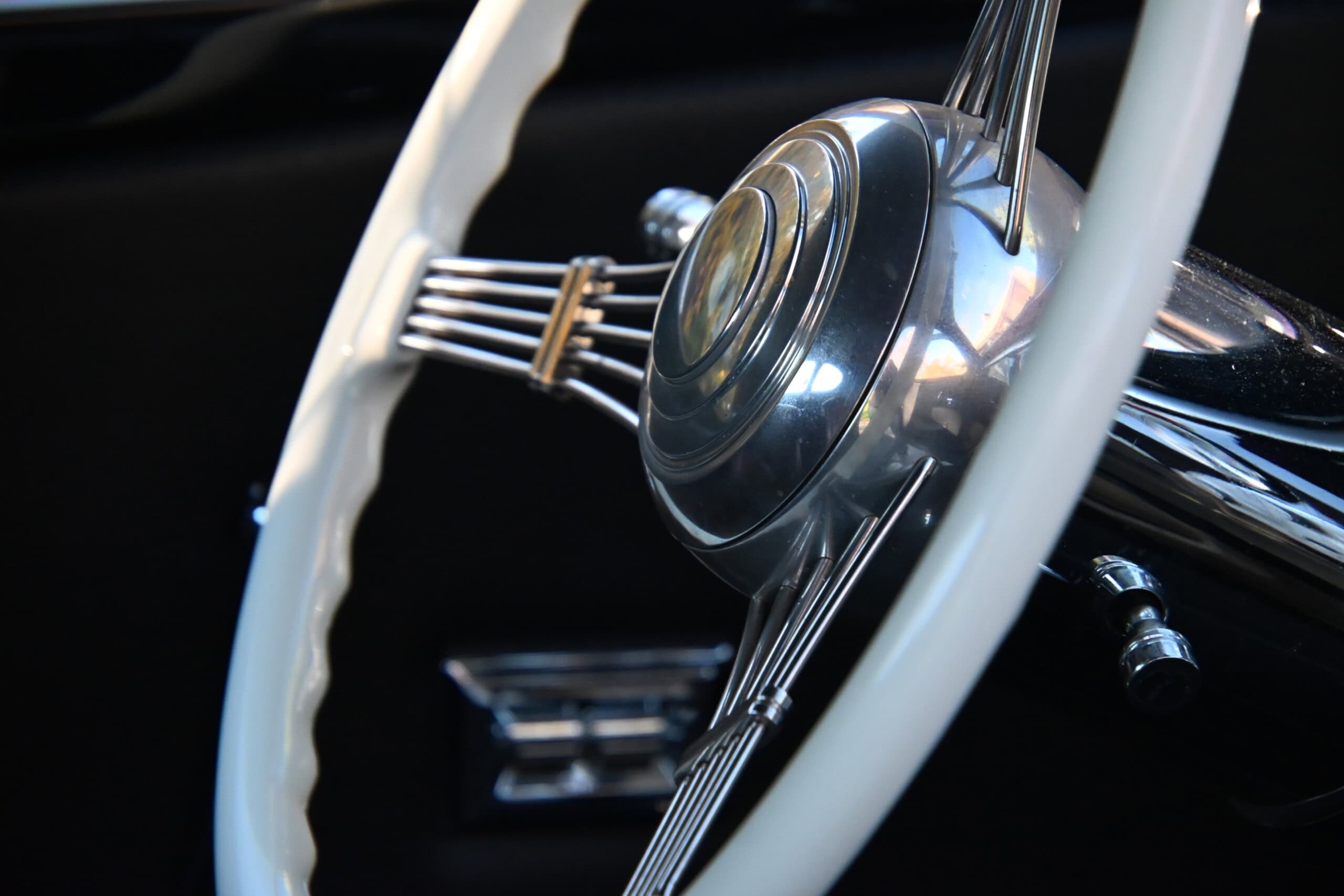 1941 Willys Custom Street Rod — Close-up of a vintage car steering wheel with chrome details.