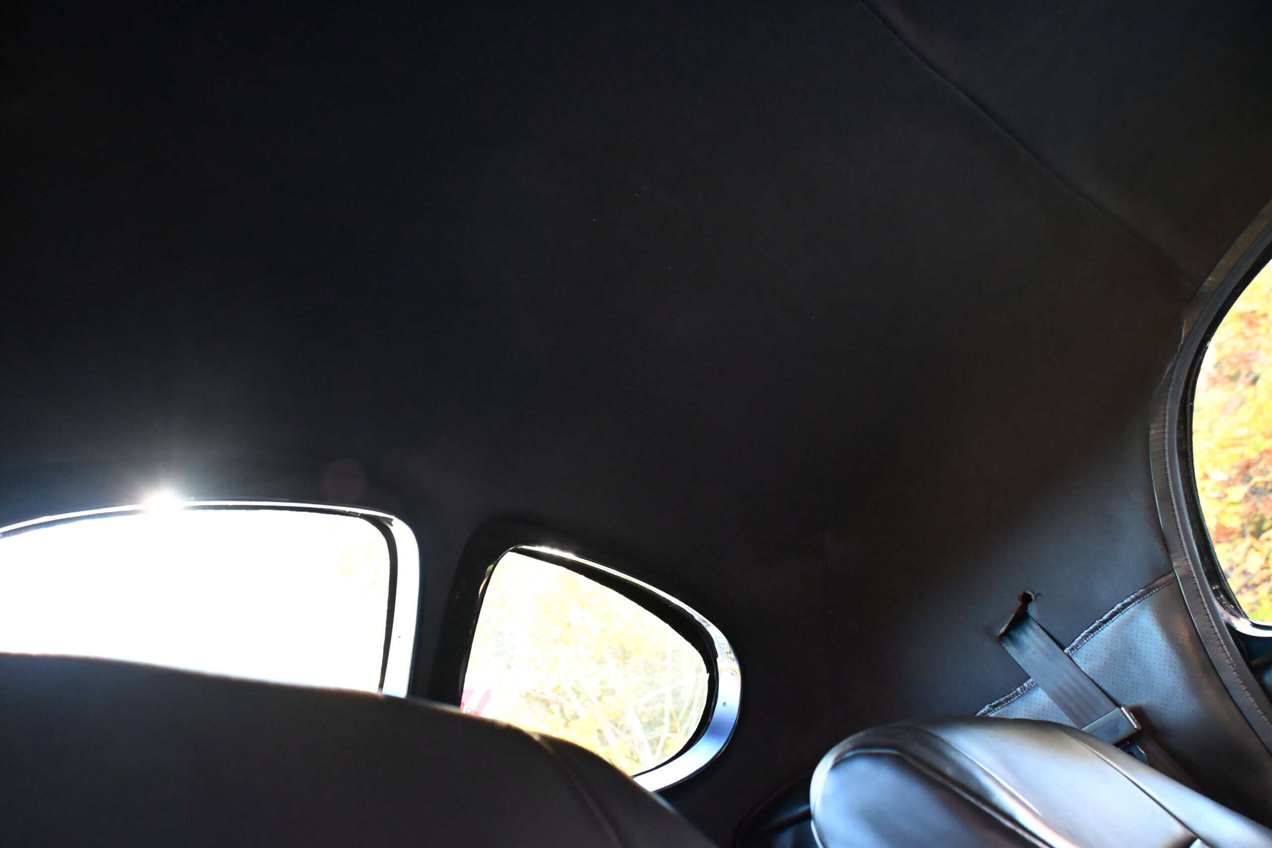 1941 Willys Custom Street Rod — Interior of a classic car showing black seats and ceiling.