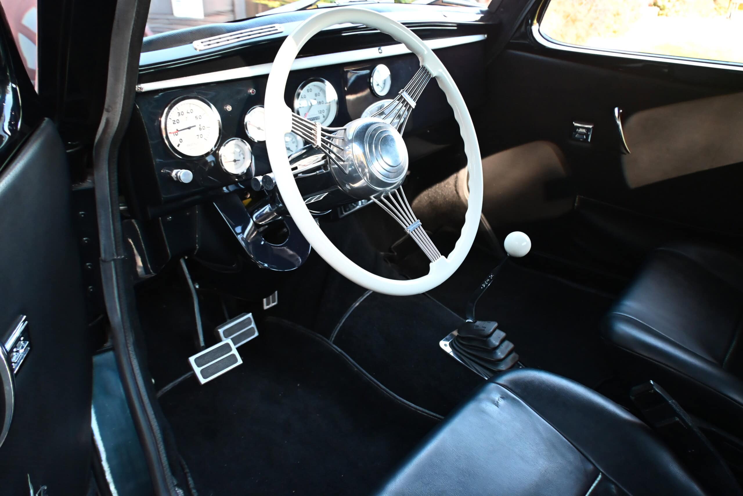 1941 Willys Custom Street Rod — Interior view of a classic car showing steering wheel and gear shift.