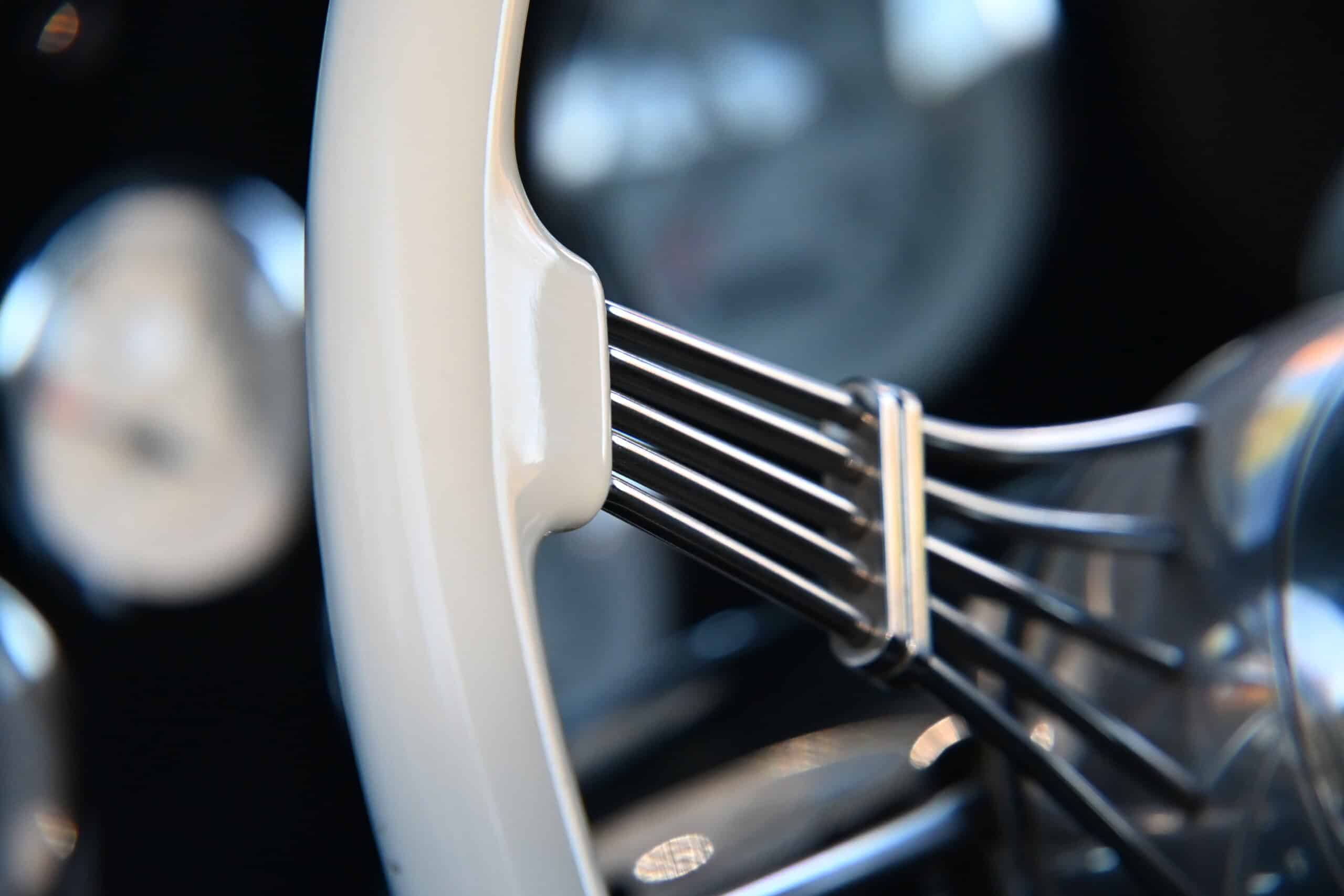 1941 Willys Custom Street Rod — Close-up of classic car steering wheel with spokes and white rim.
