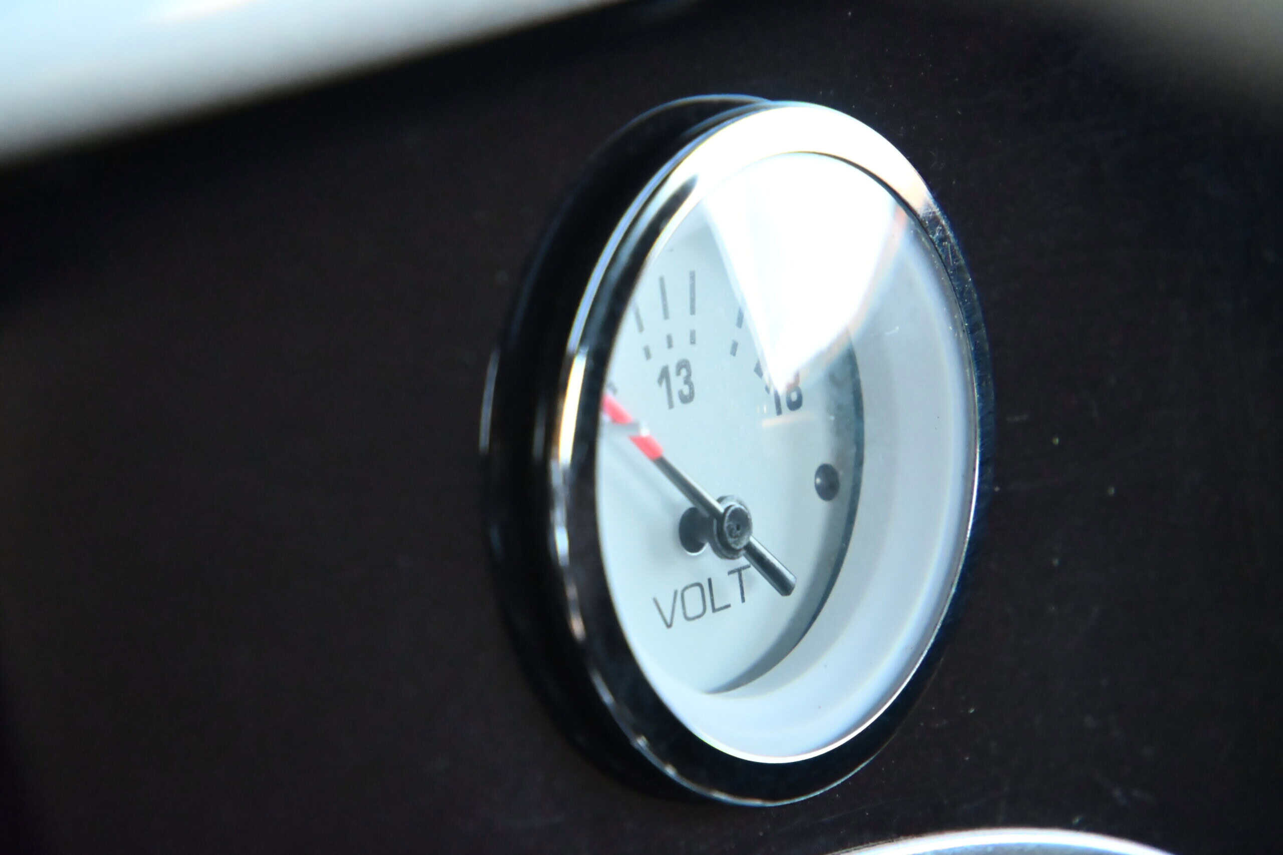 1941 Willys Custom Street Rod — Close-up of a classic car voltmeter gauge showing voltage levels.