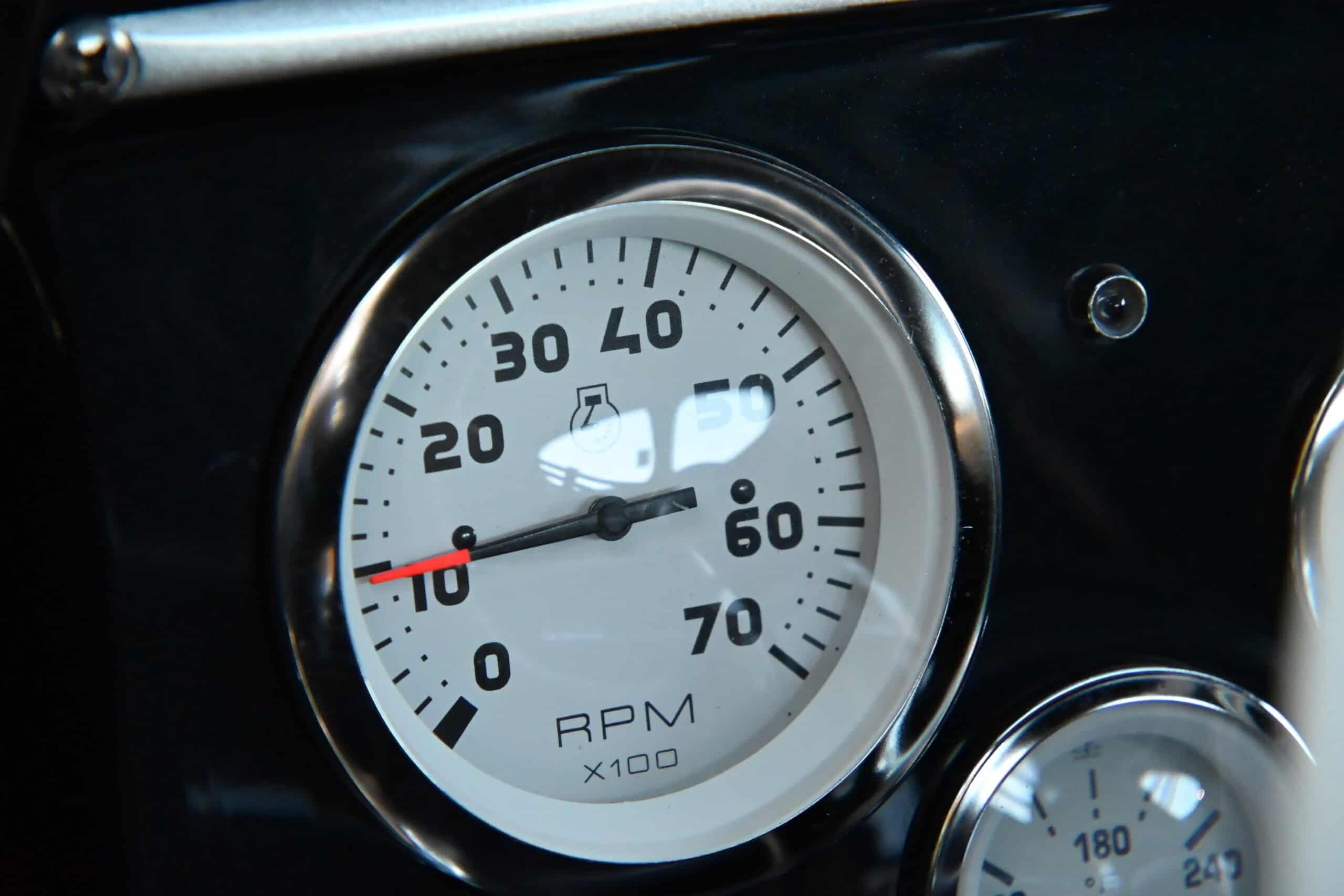 1941 Willys Custom Street Rod — Close-up of a classic car RPM gauge with white face and black markings.