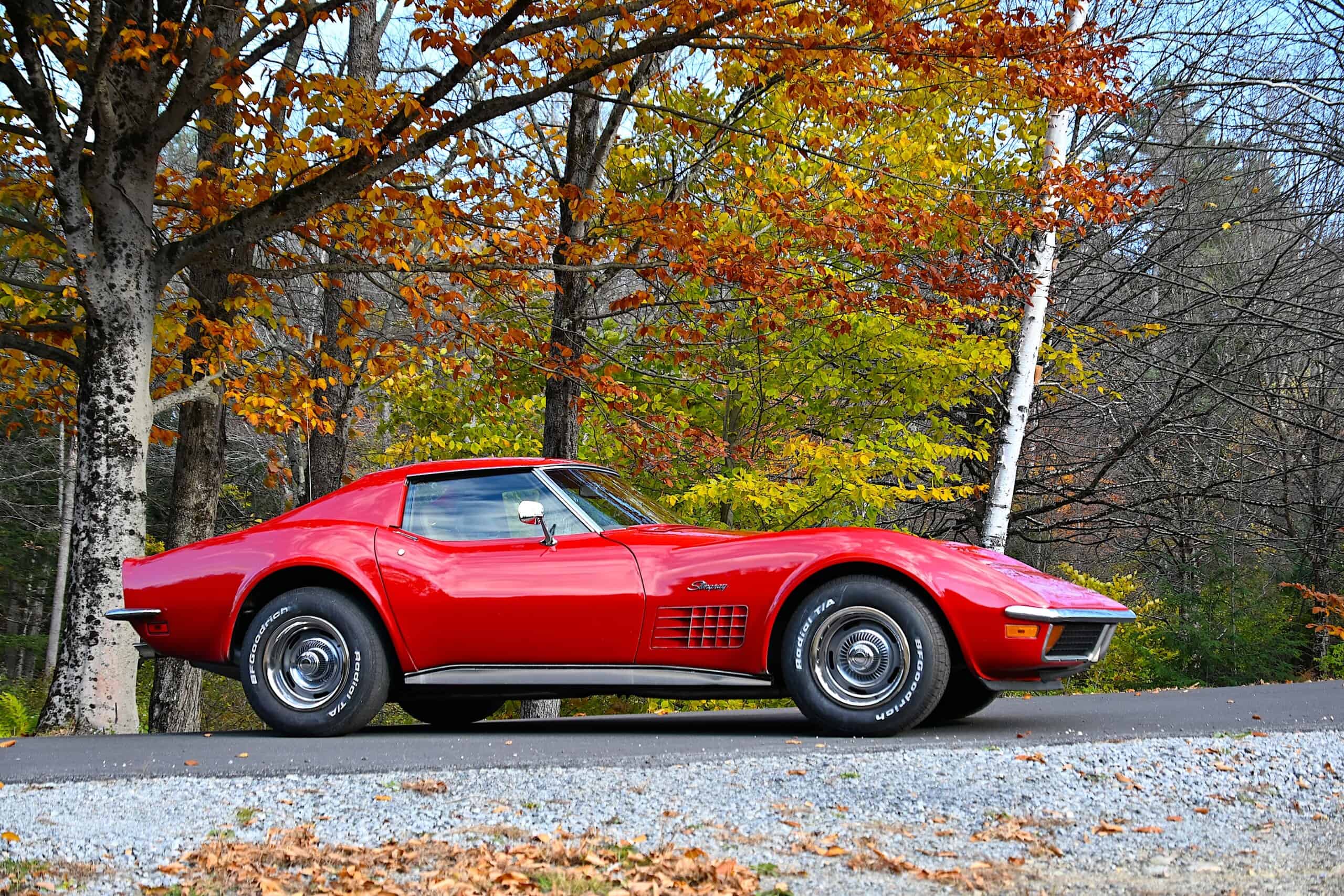 1972 Chevrolet corvette — Red classic car exterior shot with autumn trees in background.
