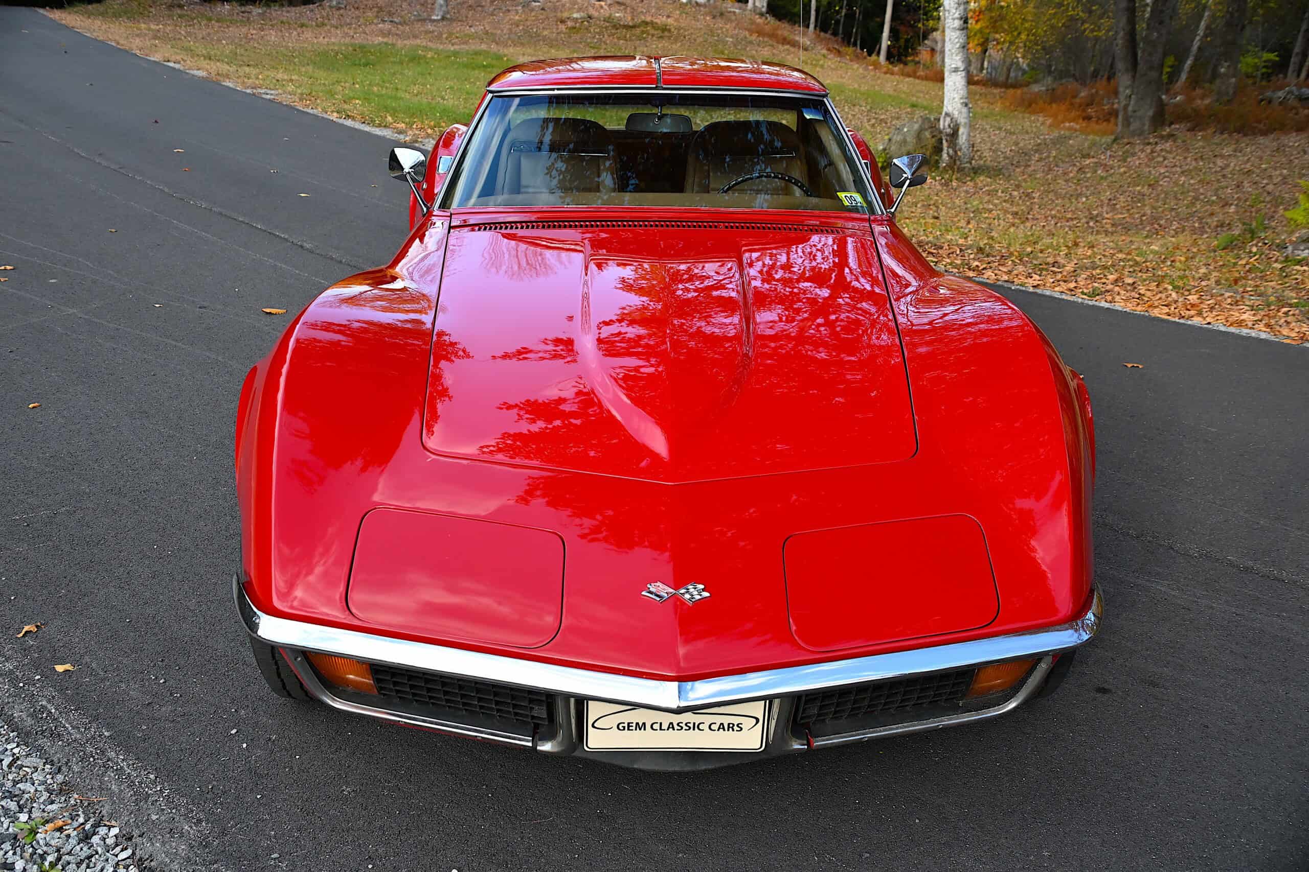 1972 Chevrolet corvette — Red classic car exterior shot on road with trees in background.