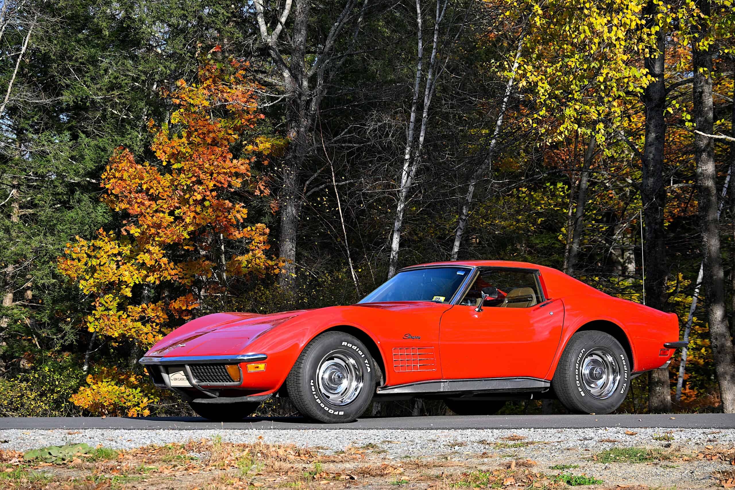 1972 Chevrolet corvette — Red classic car with sleek body and chrome wheels on road.