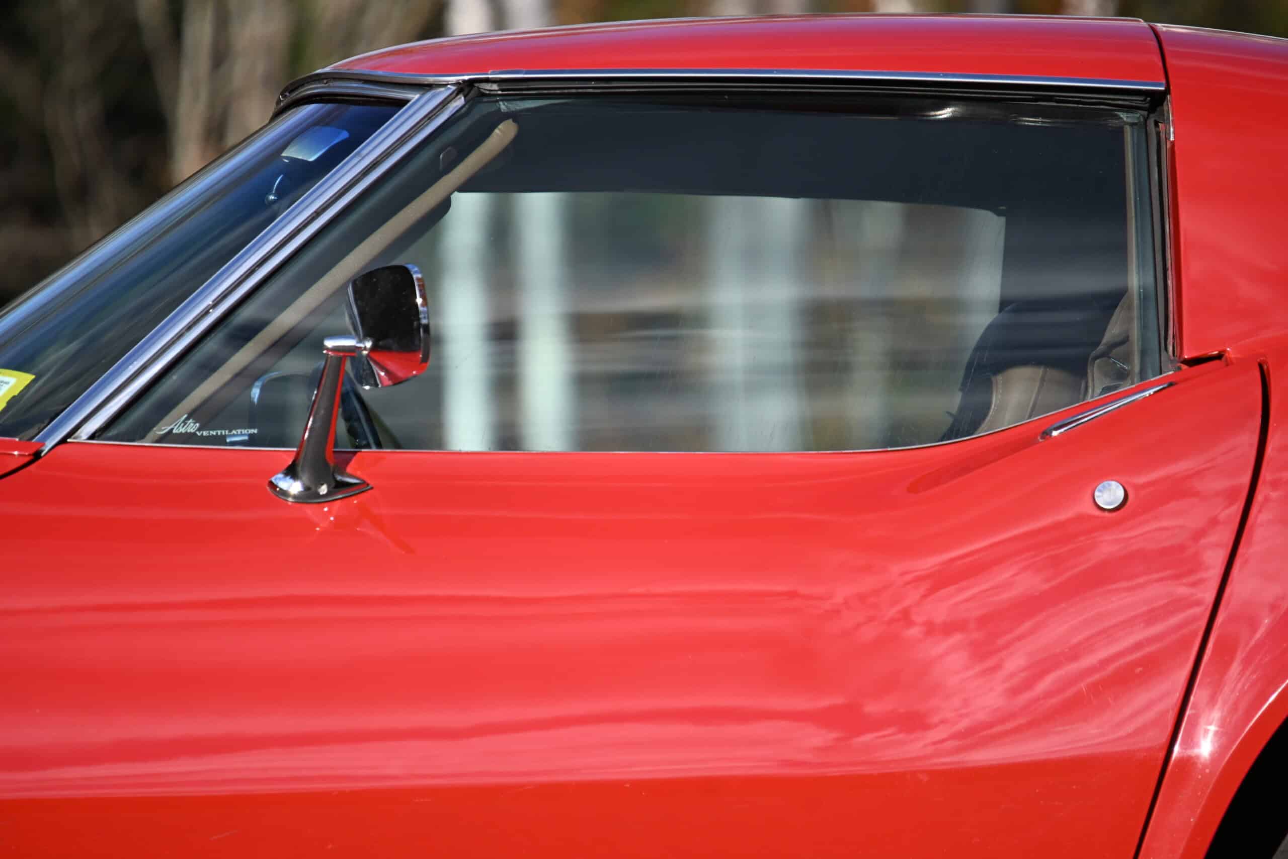 1972 Chevrolet corvette — Close-up of classic car door and side mirror.