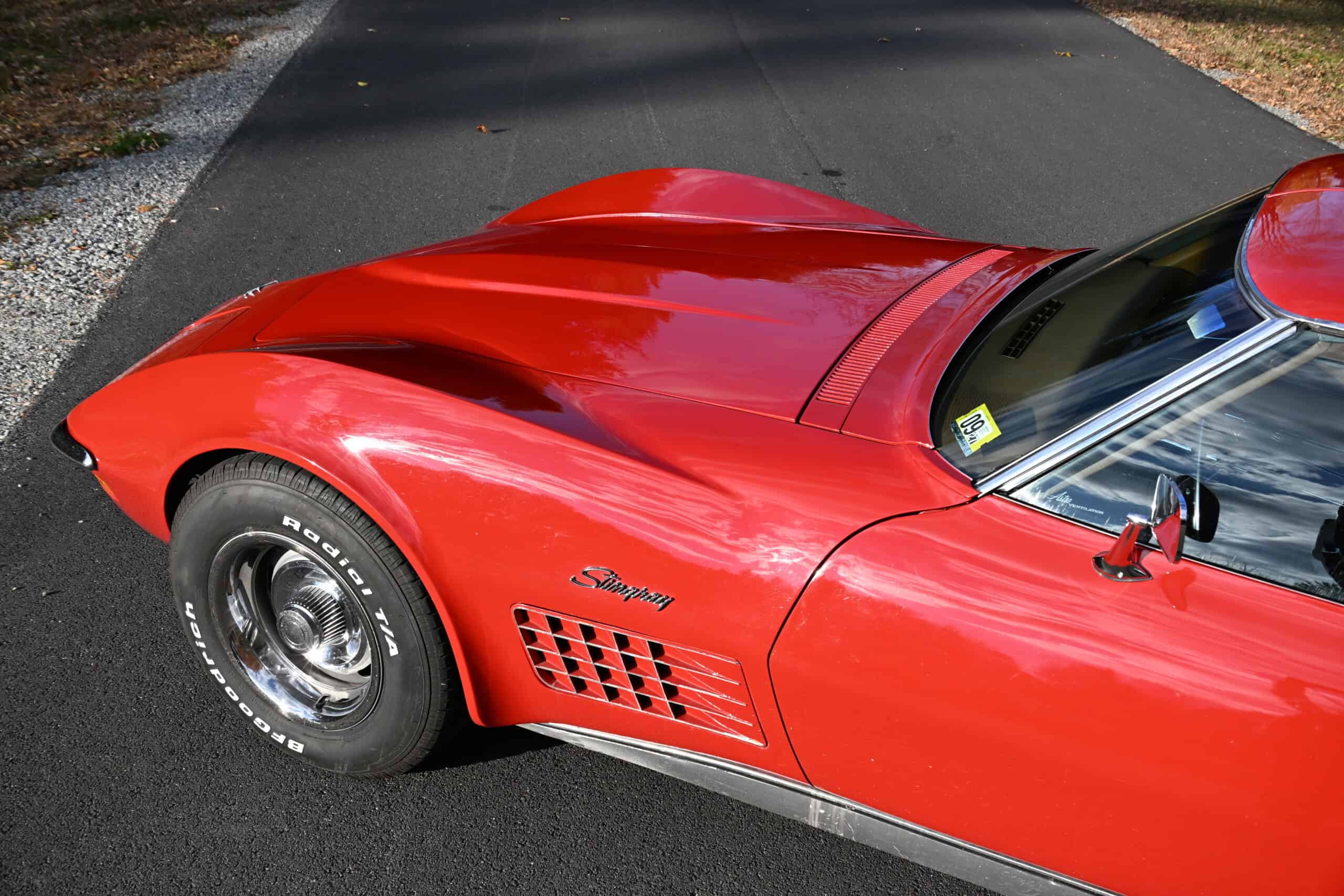 1972 Chevrolet corvette — Red classic car front exterior with sleek body and wheel.