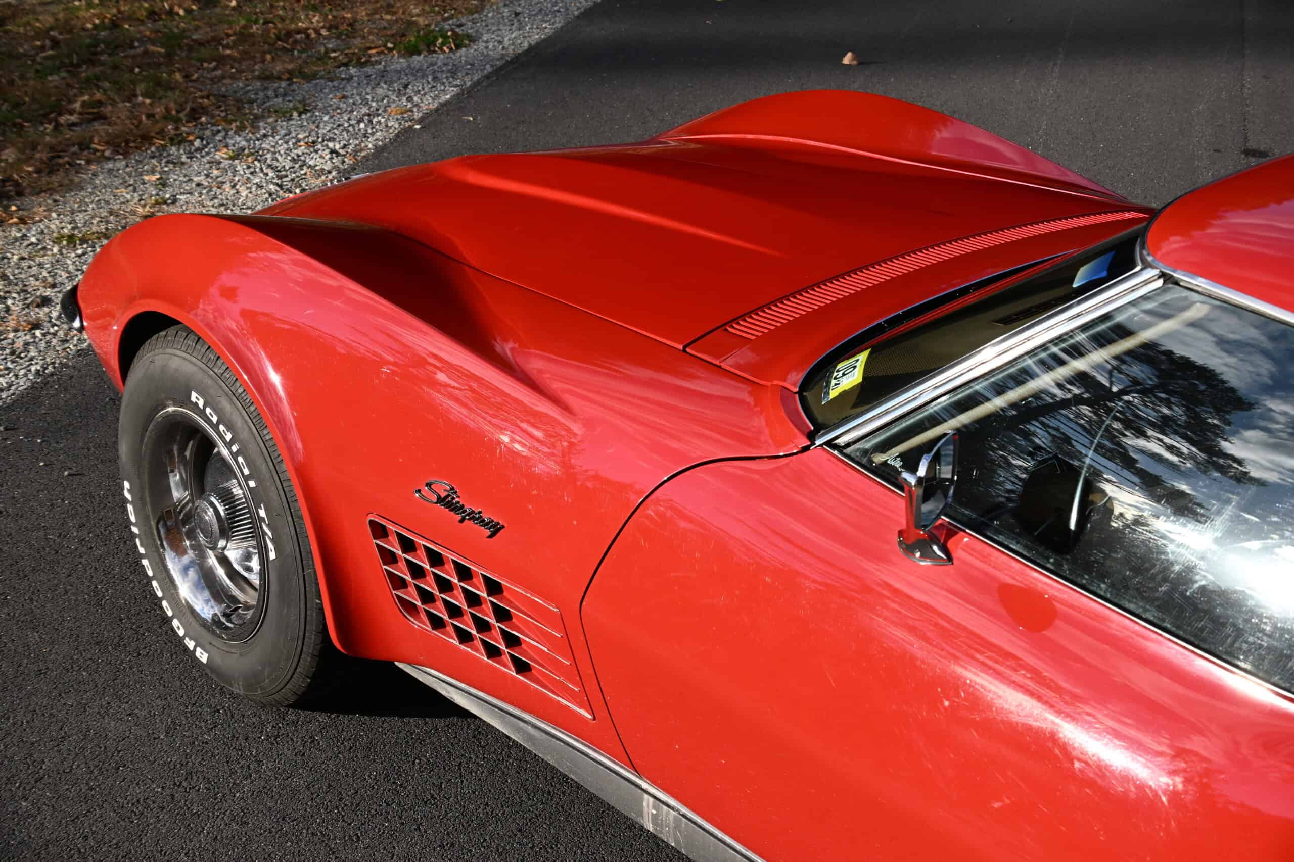 1972 Chevrolet corvette — Red classic car with sleek body and black tires.