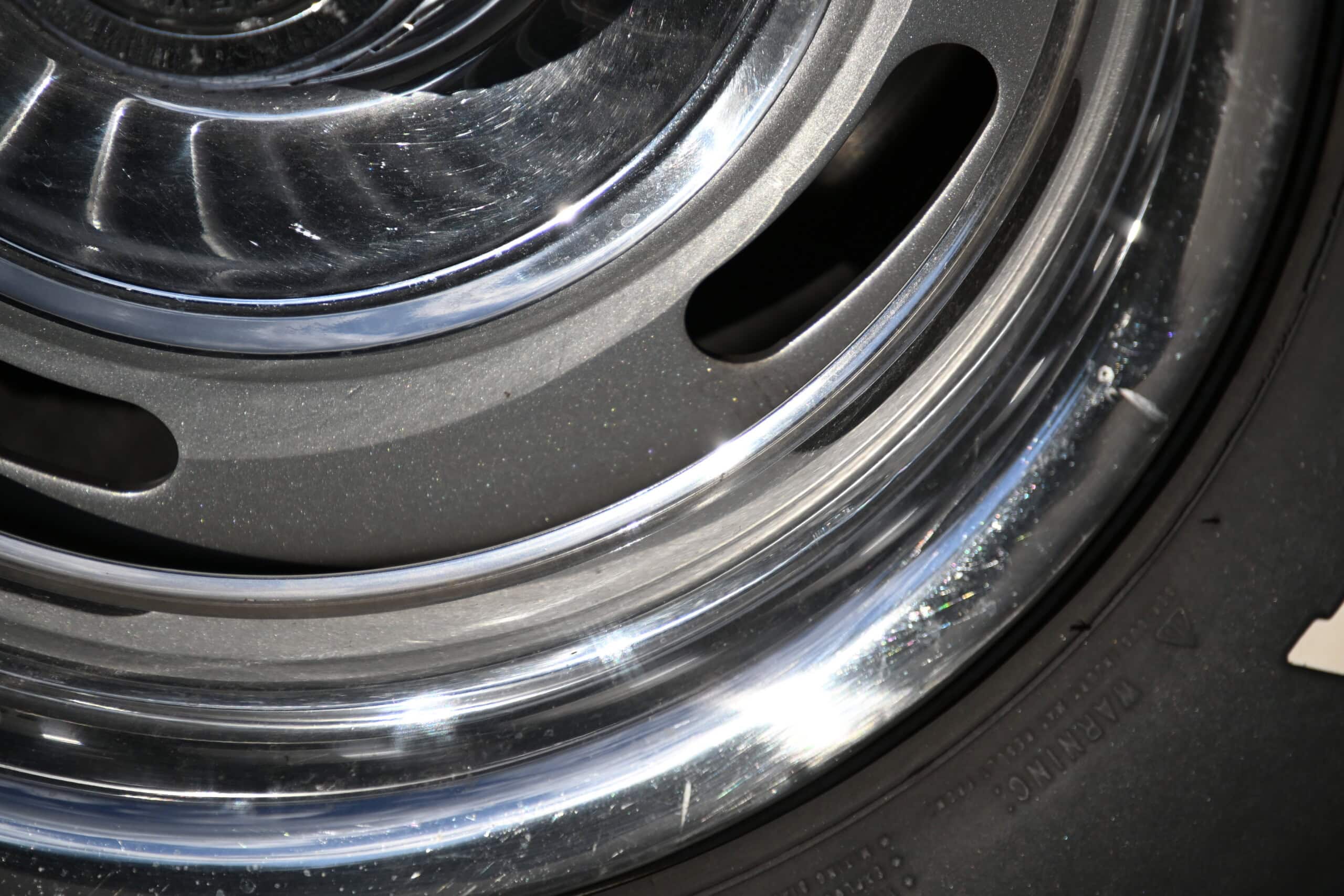 1972 Chevrolet corvette — Close-up of a classic car wheel with chrome rim and black tire.