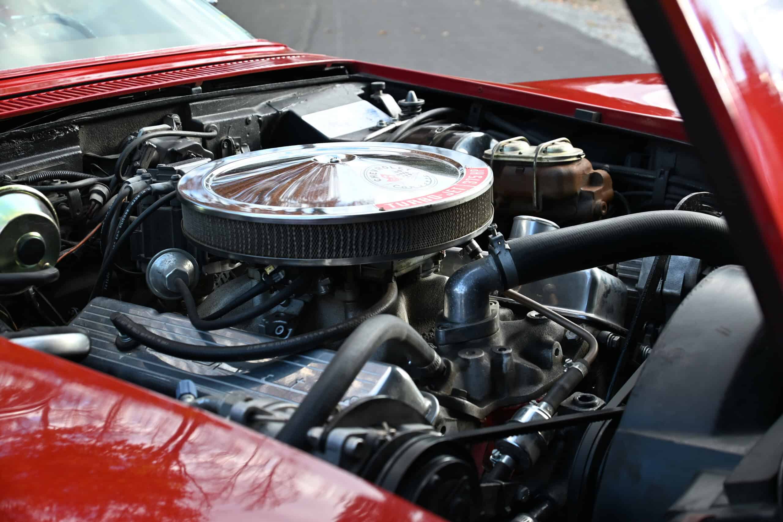 1972 Chevrolet corvette — Close-up of a classic car engine with chrome air filter and hoses.