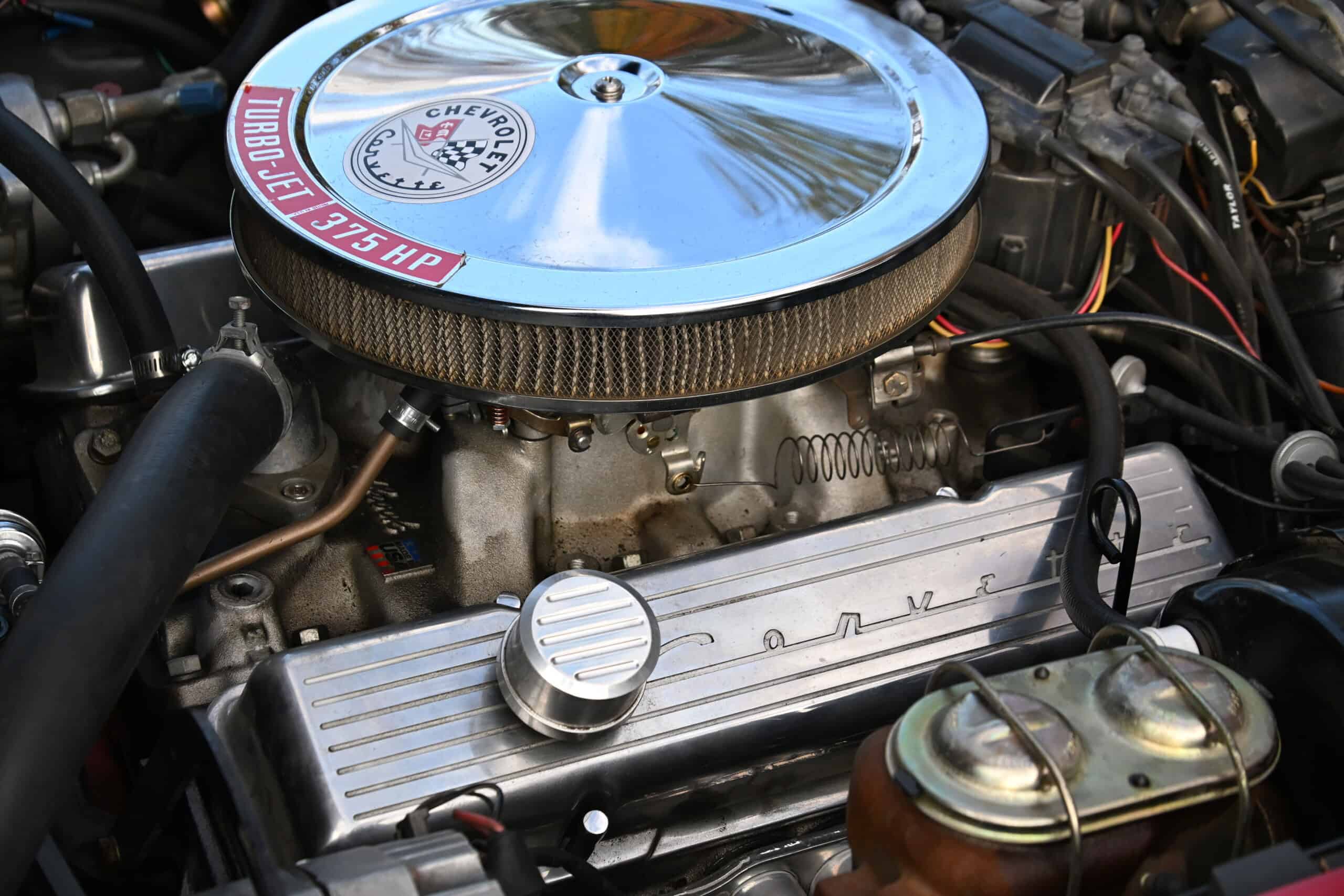 1972 Chevrolet corvette — Close-up of a classic car engine with chrome air filter and valve cover.