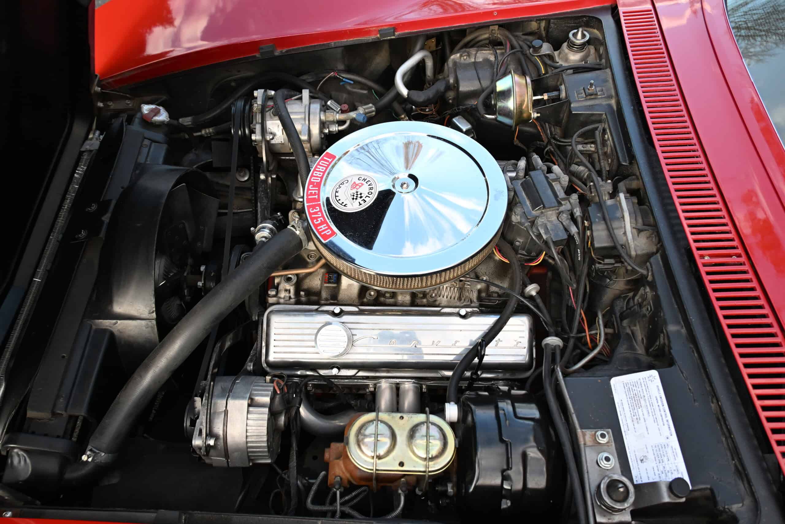 1972 Chevrolet corvette — Engine bay of a classic car showing chrome air cleaner and engine components.