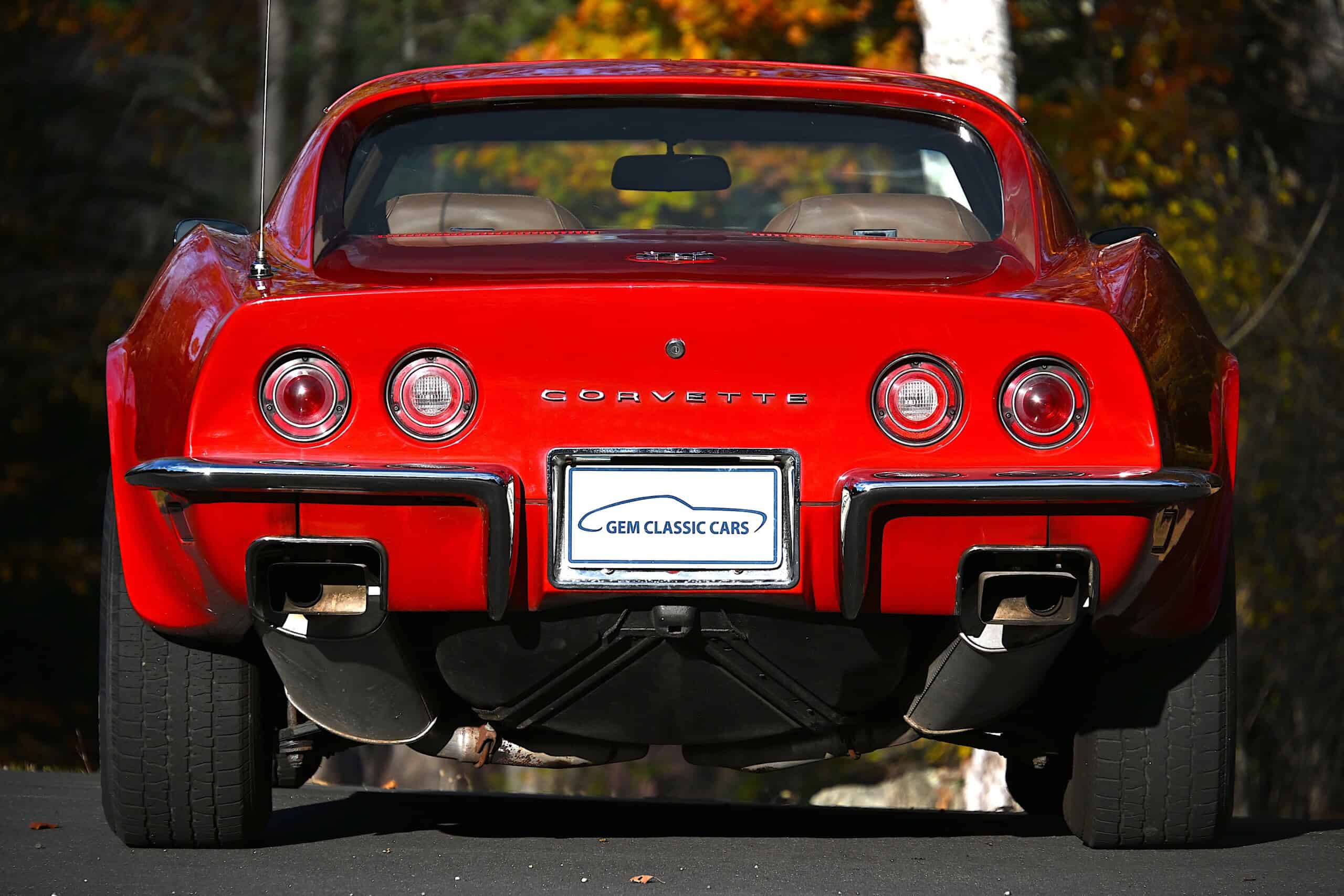 1972 Chevrolet corvette — Red classic car with round taillights and dual exhausts.
