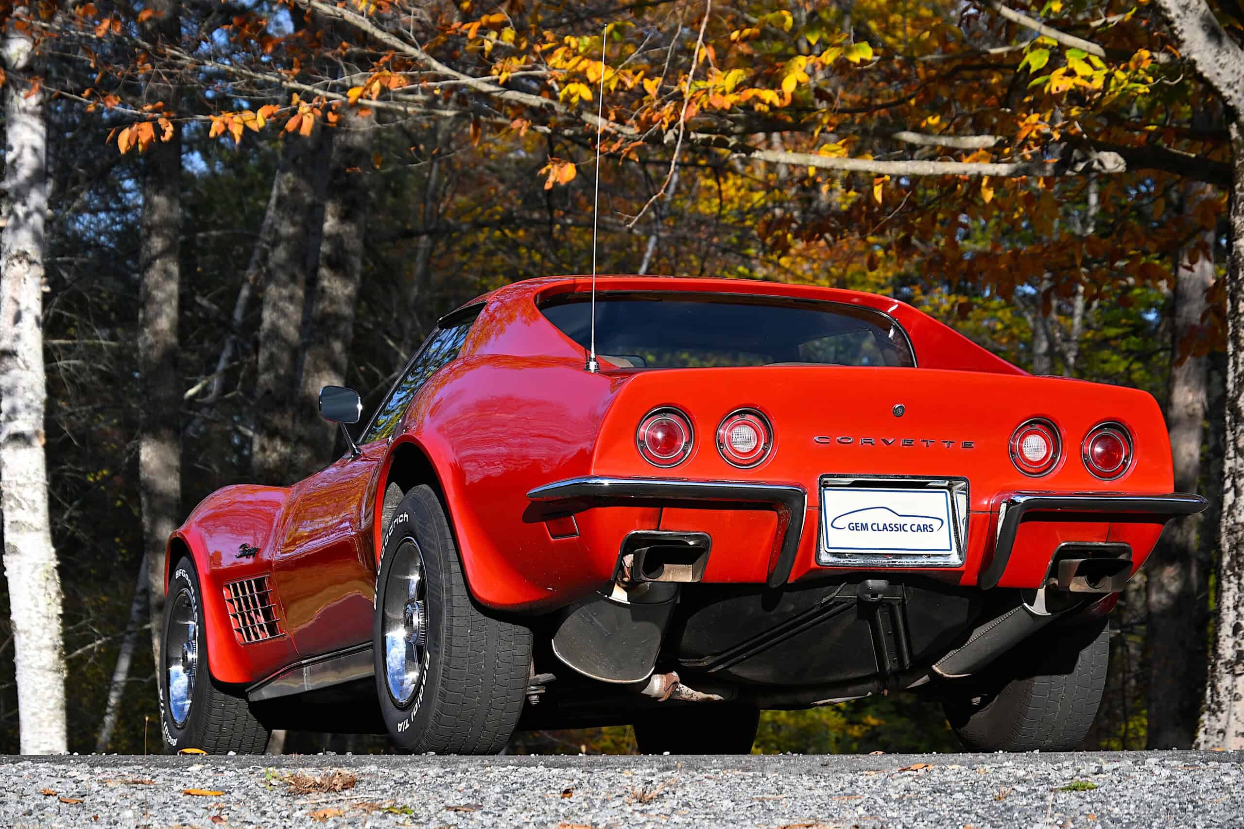 1972 Chevrolet corvette — Red classic car with round taillights and sporty design.