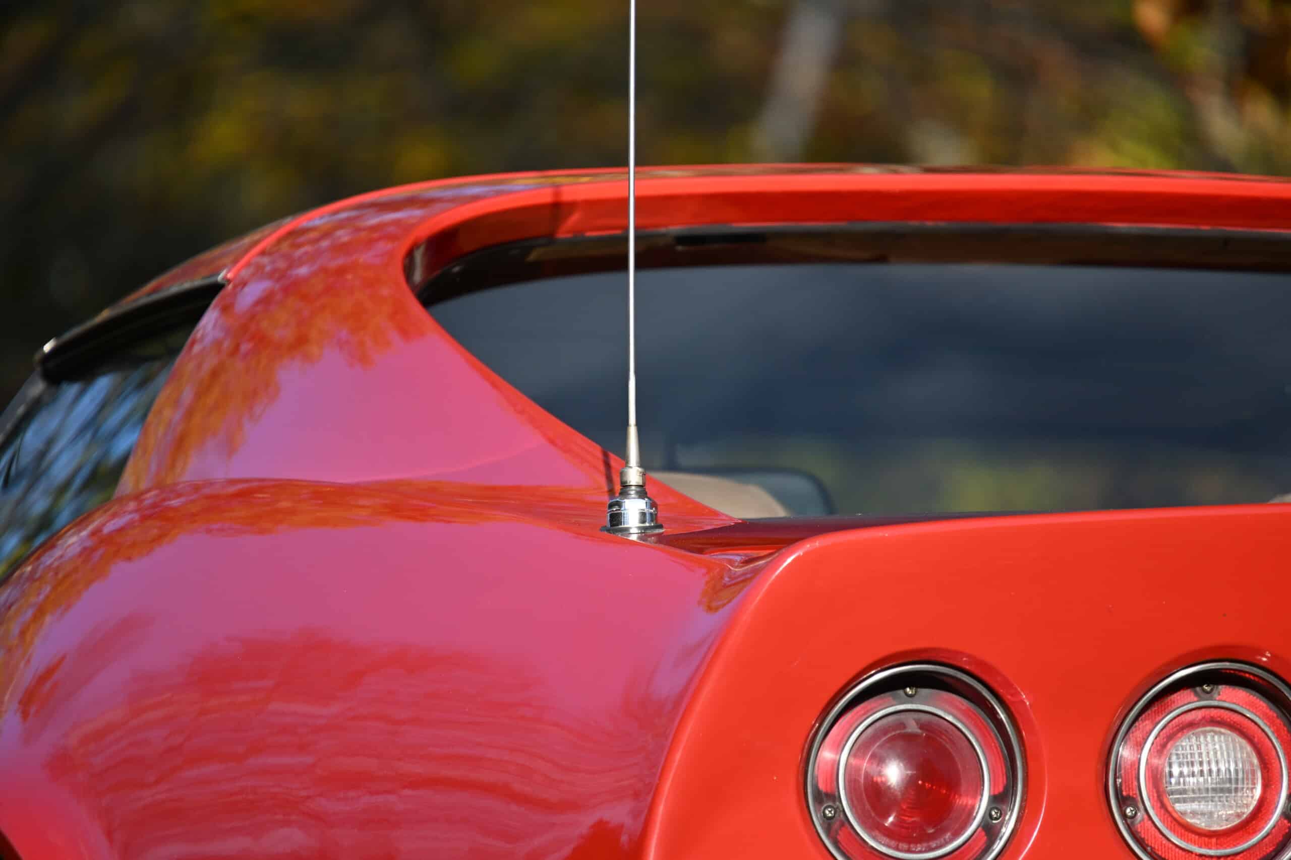1972 Chevrolet corvette — Close-up of the rear of a red classic car with round taillights.