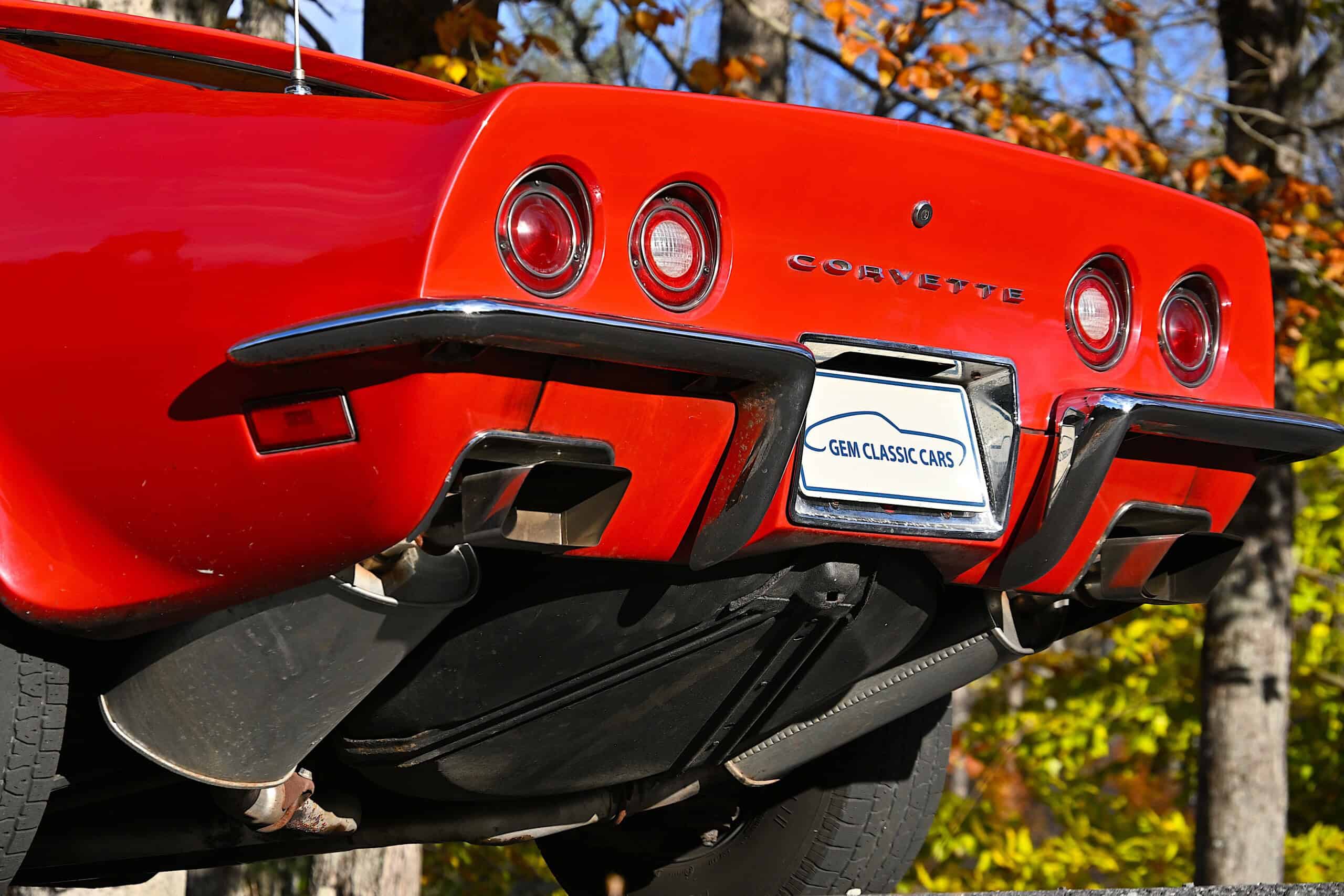 1972 Chevrolet corvette — Rear view of a red classic car with round taillights and black bumper.