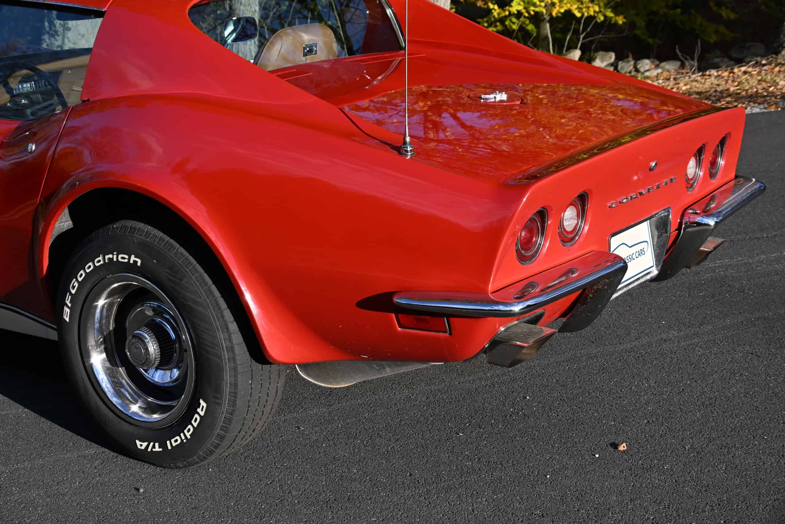 1972 Chevrolet corvette — Rear view of a red classic car with round taillights and chrome bumper.