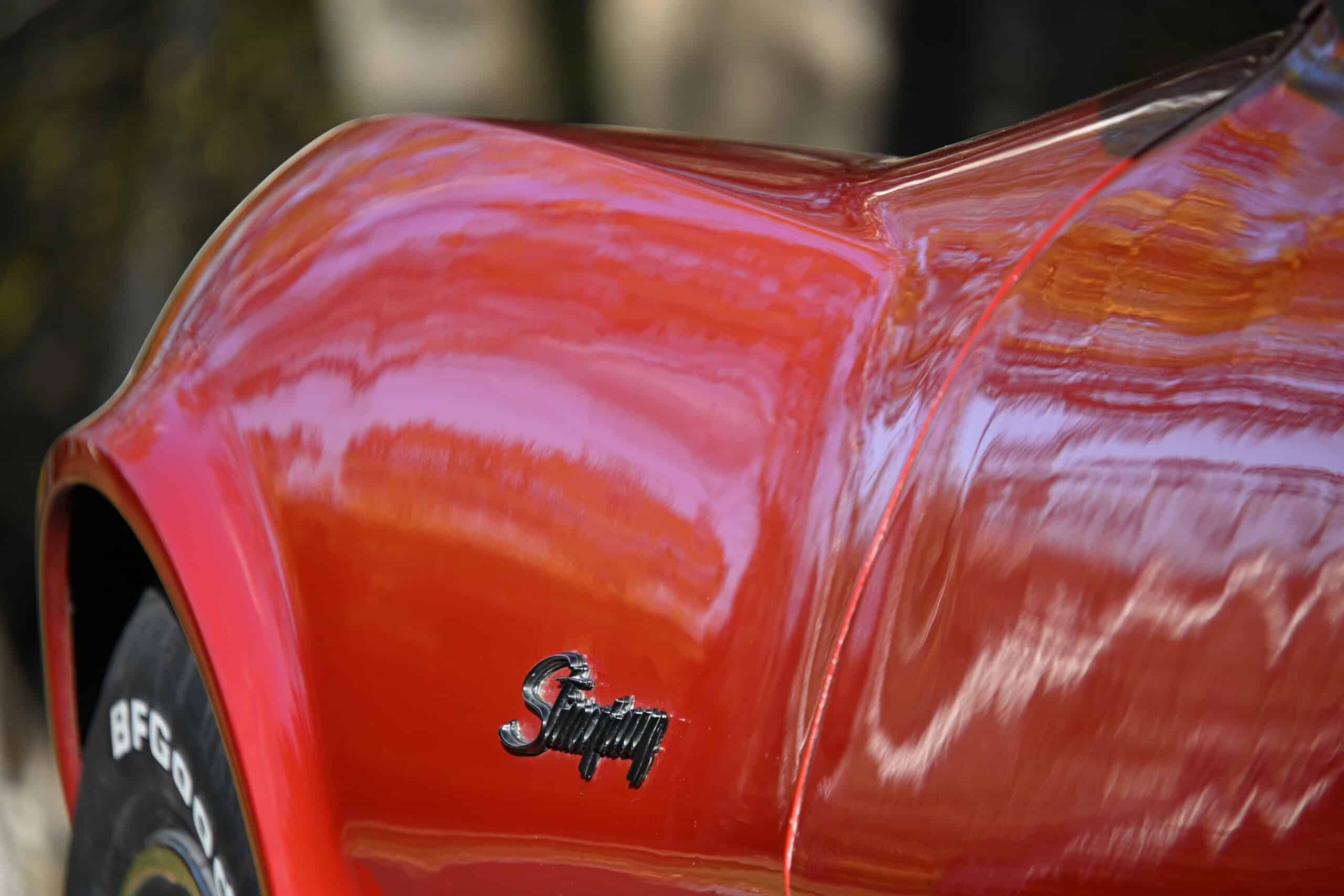 1972 Chevrolet corvette — Close-up of the red classic car body with 'Sting' badge.
