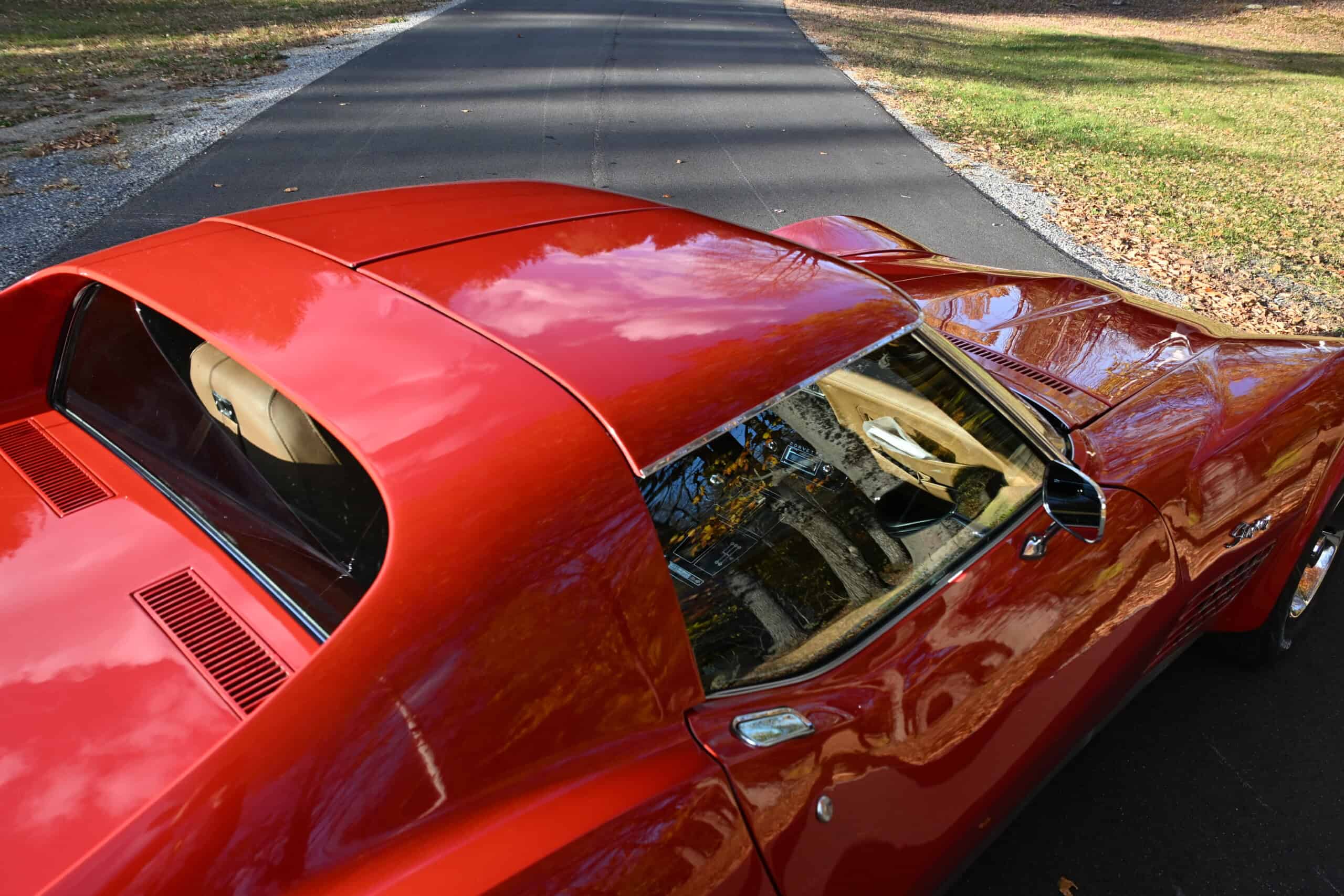 1972 Chevrolet corvette — Red classic car with sleek body and tinted windows.