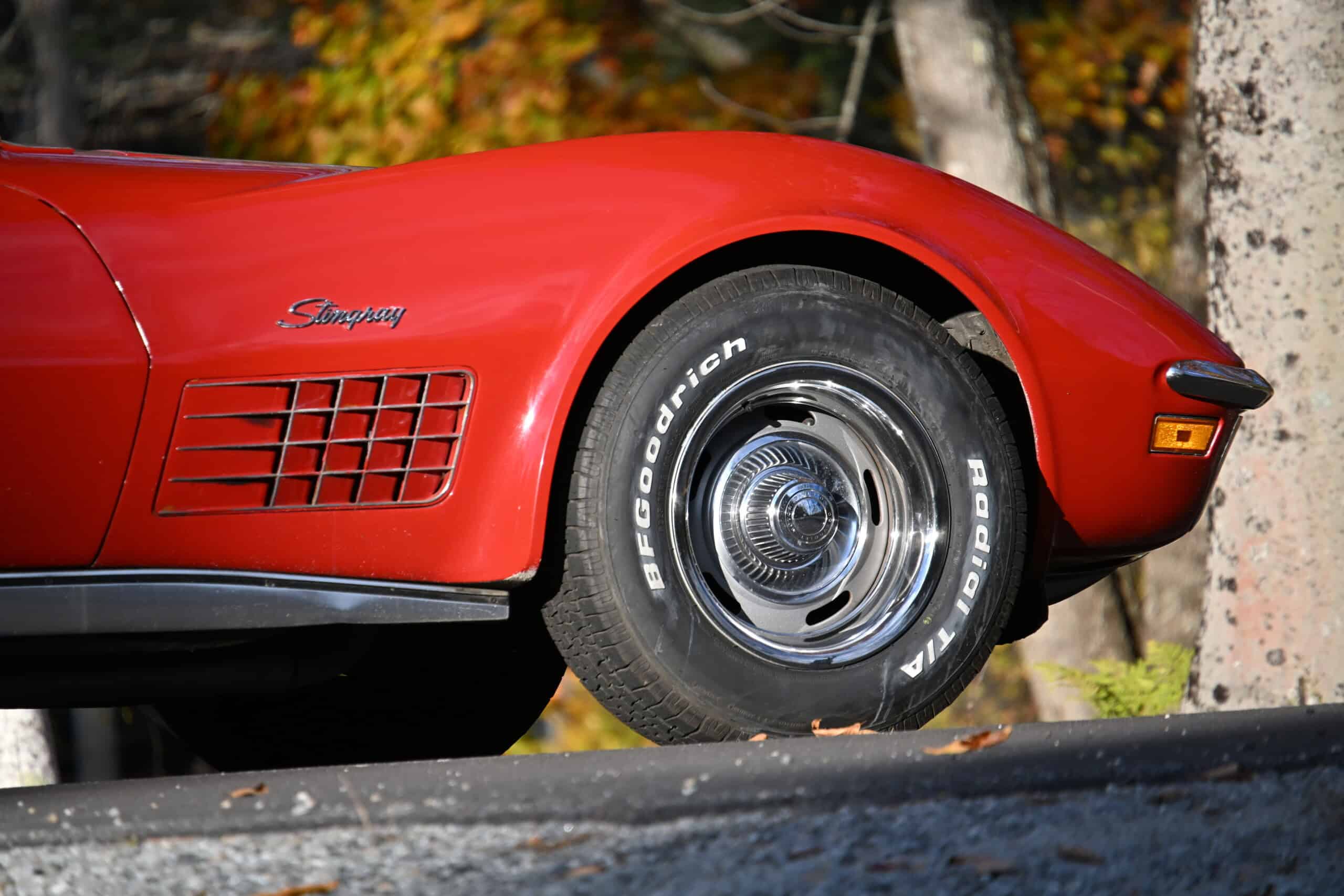 1972 Chevrolet corvette — Red classic car wheel and side panel with vent details.