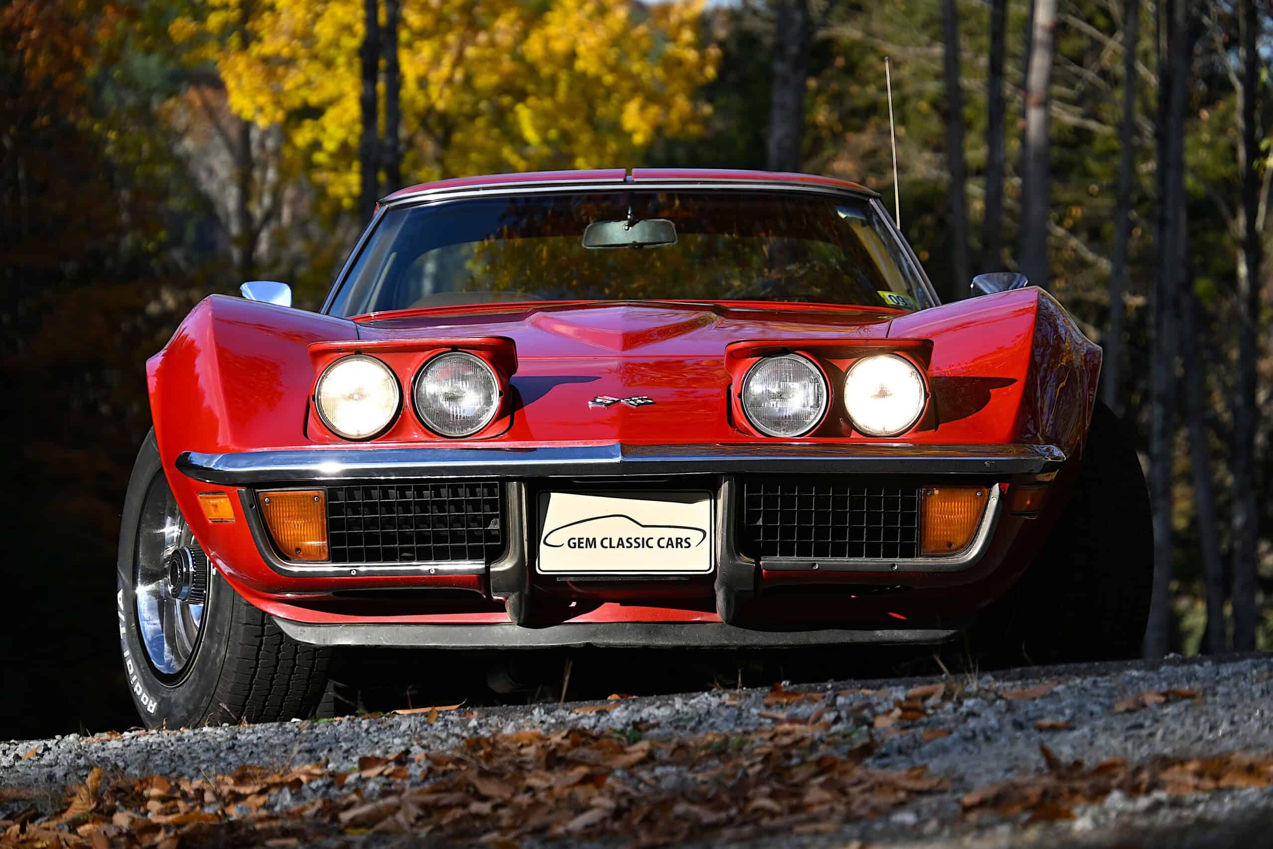 1972 Chevrolet corvette — Red classic car with round headlights and sleek body style.
