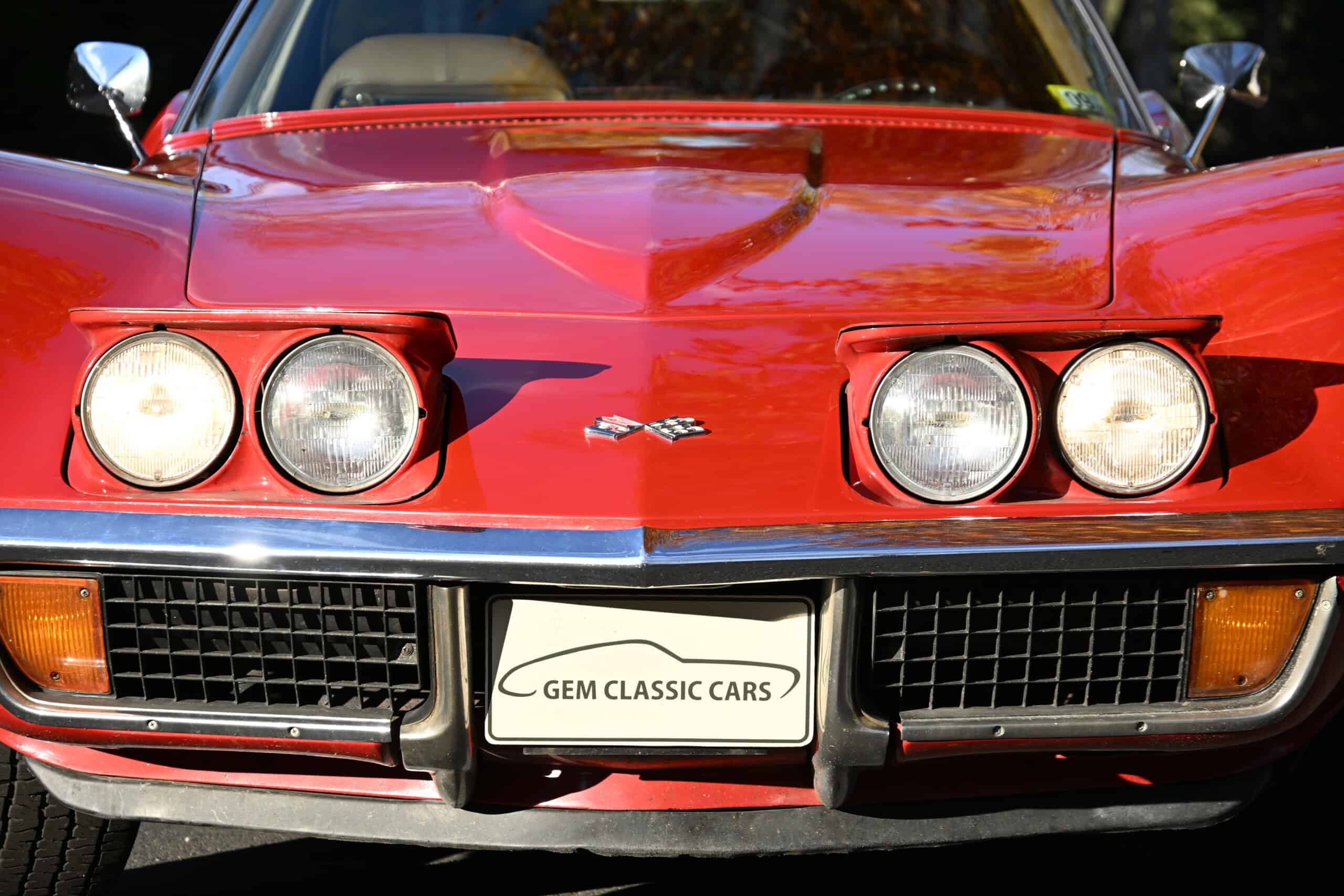1972 Chevrolet corvette — Front view of a classic car with round headlights and red body.