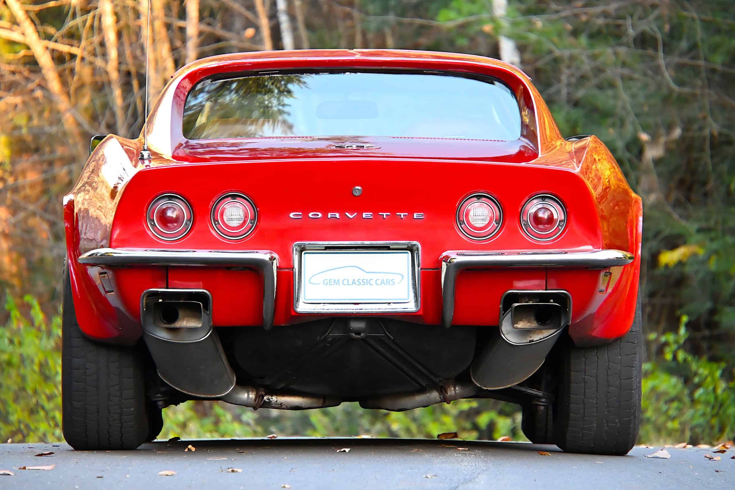 1972 Chevrolet corvette — Rear view of a red classic car with round taillights and dual exhausts.