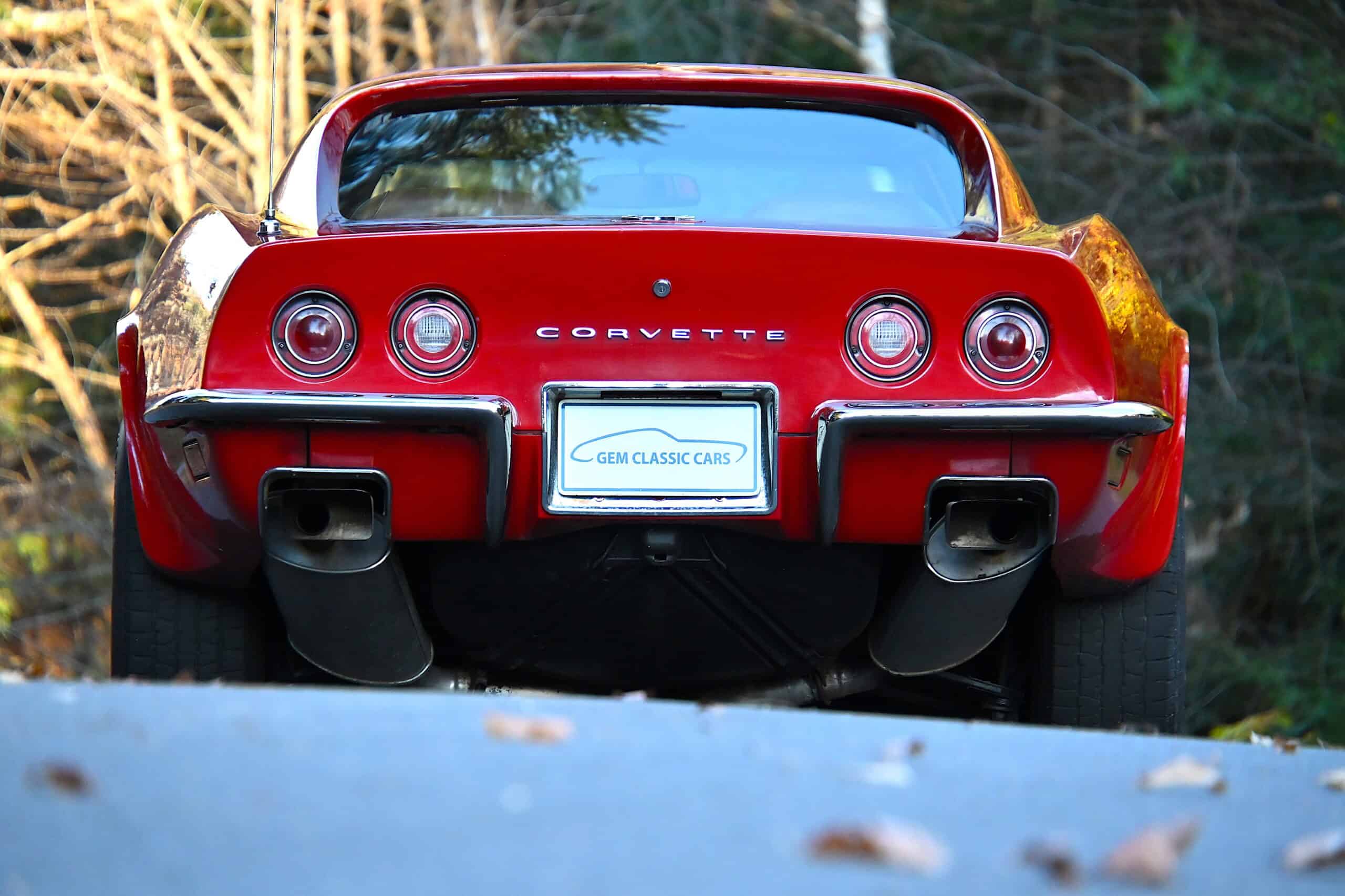 1972 Chevrolet corvette — Red classic car rear shot with round taillights and dual exhausts.
