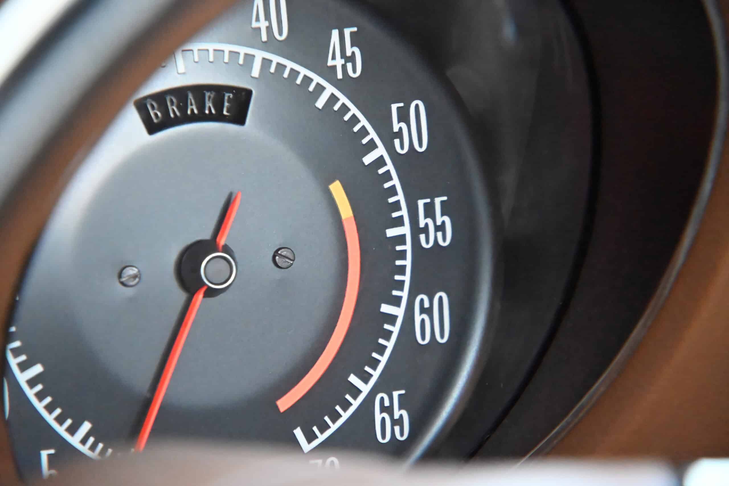 1972 Chevrolet corvette — Close-up of a classic car speedometer with brake warning light.