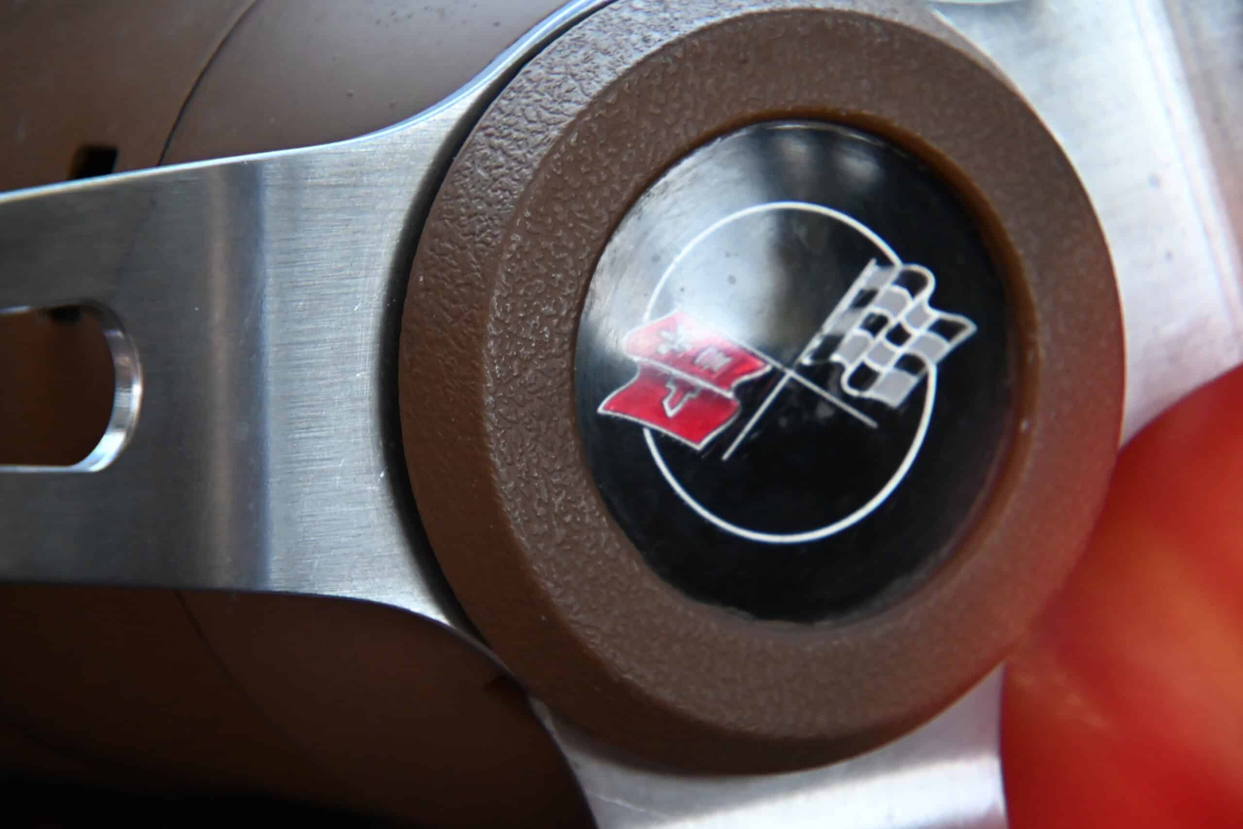 1972 Chevrolet corvette — Close-up of a classic car steering wheel with logo.