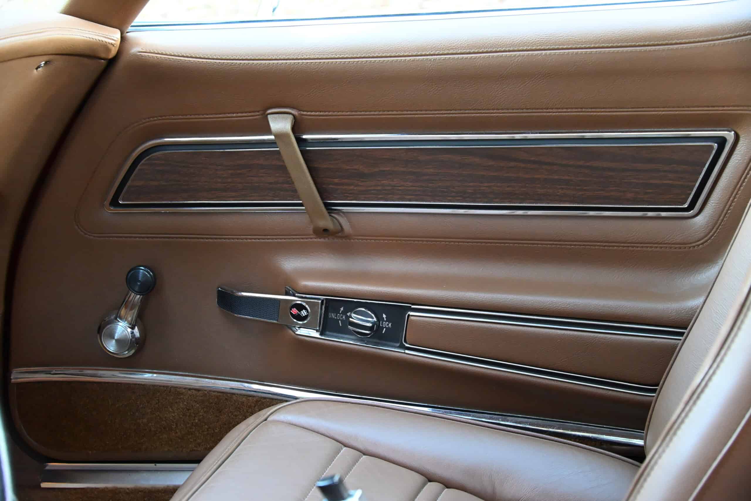1972 Chevrolet corvette — Interior door panel of a classic car with wood trim and controls.