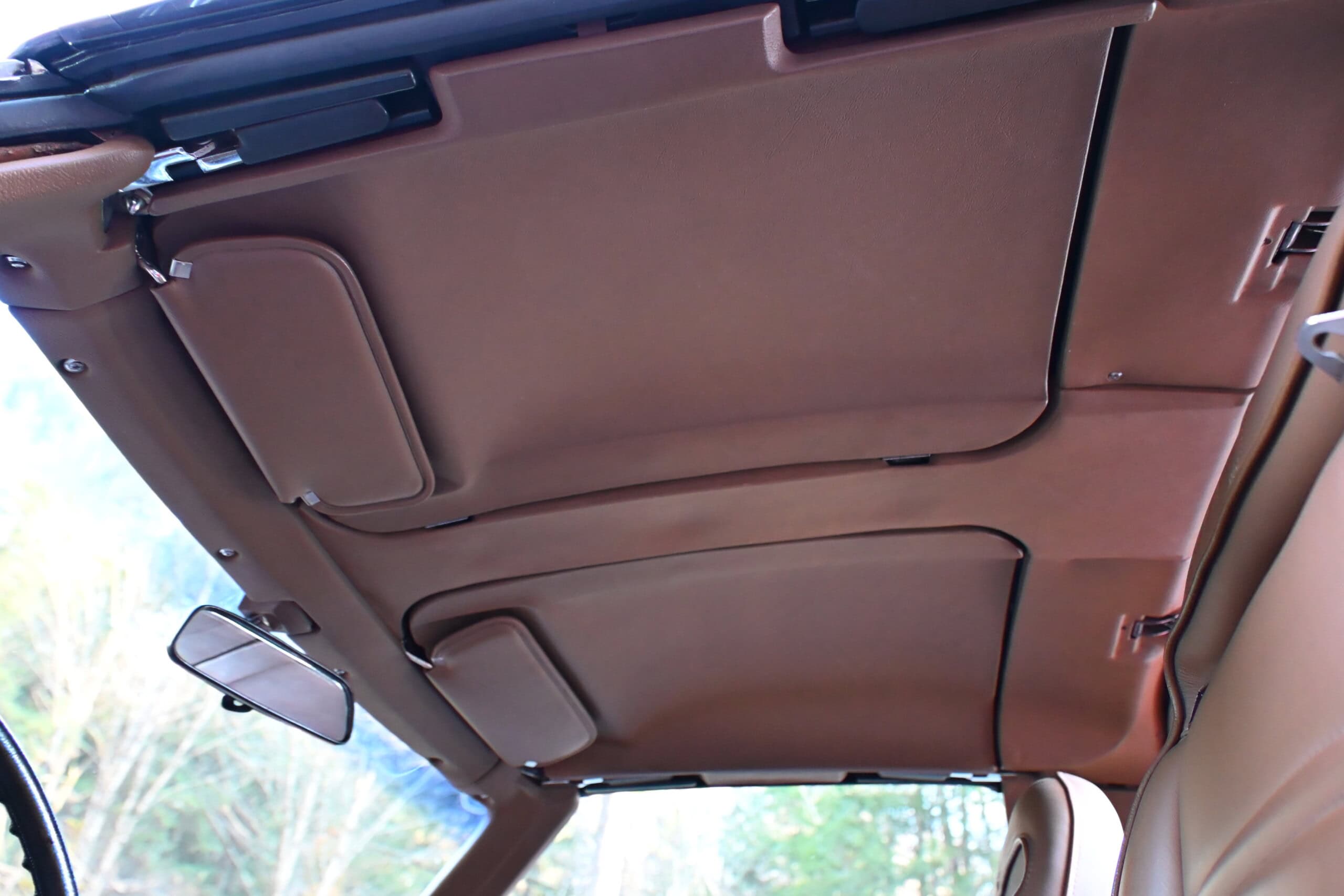 1972 Chevrolet corvette — Interior view of classic car roof with sun visors and rearview mirror.