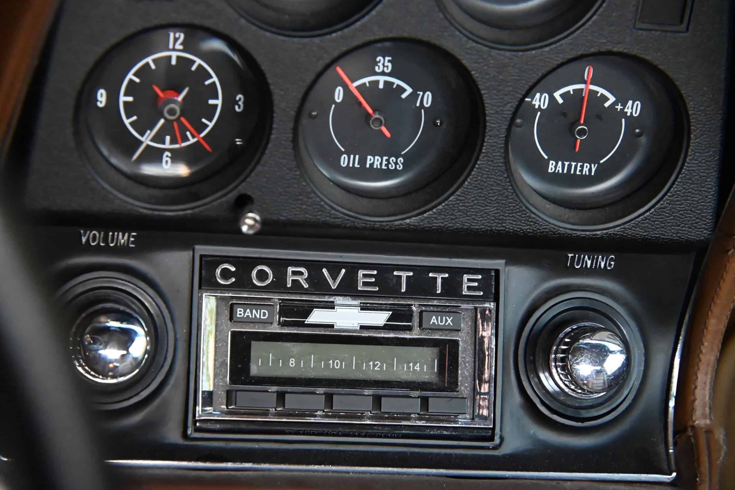 1972 Chevrolet corvette — Close-up of classic car dashboard with oil, battery gauges and radio.