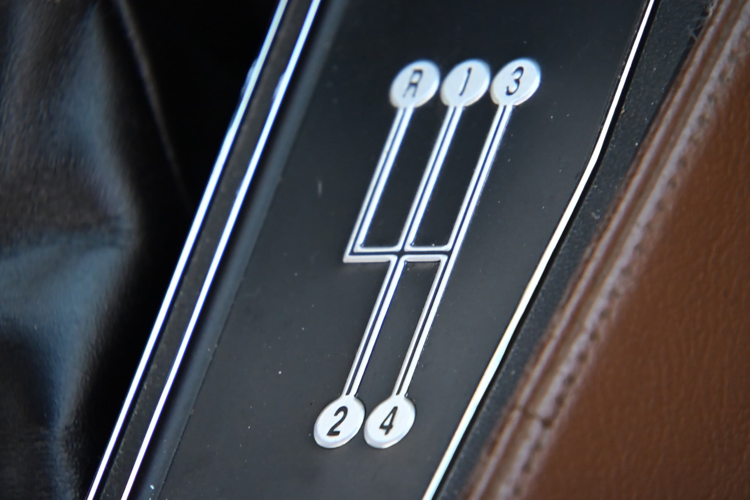 1972 Chevrolet corvette — Close-up of classic car manual gear shift with 4-speed pattern.